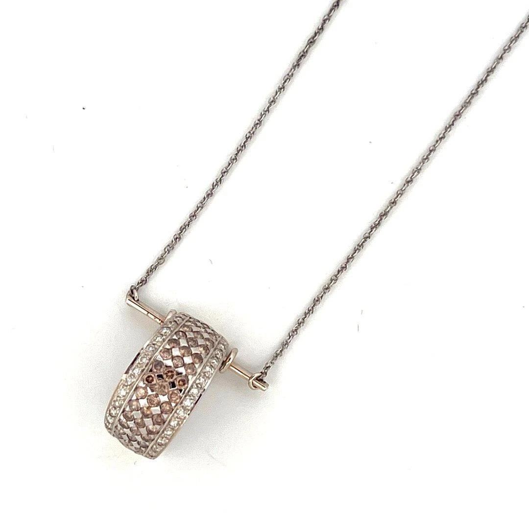 Offered here is a custom-created 14K white gold pendant necklace featuring a stunning combination of natural chocolate and white diamonds. The pendant, which was likely once a ring, has been expertly transformed into a unique bar-suspended necklace.