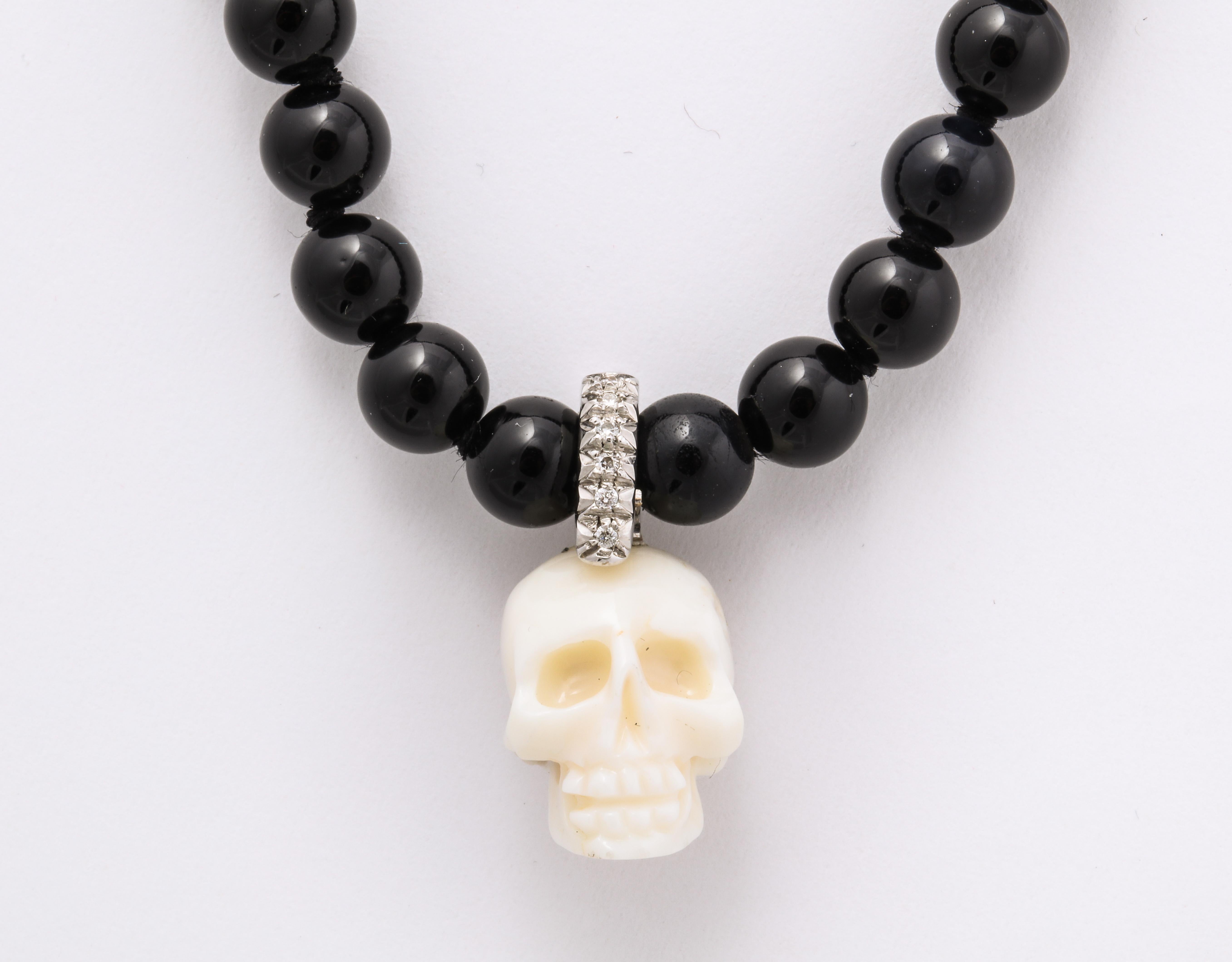 The dramatic contrast of the natural Italian white coral skull enhanced with a diamond crown on pitch black onyx beads makes for a spectacular yet simple necklace to wear anywhere and for any occasion.  As a further wonderful feature - the skull is