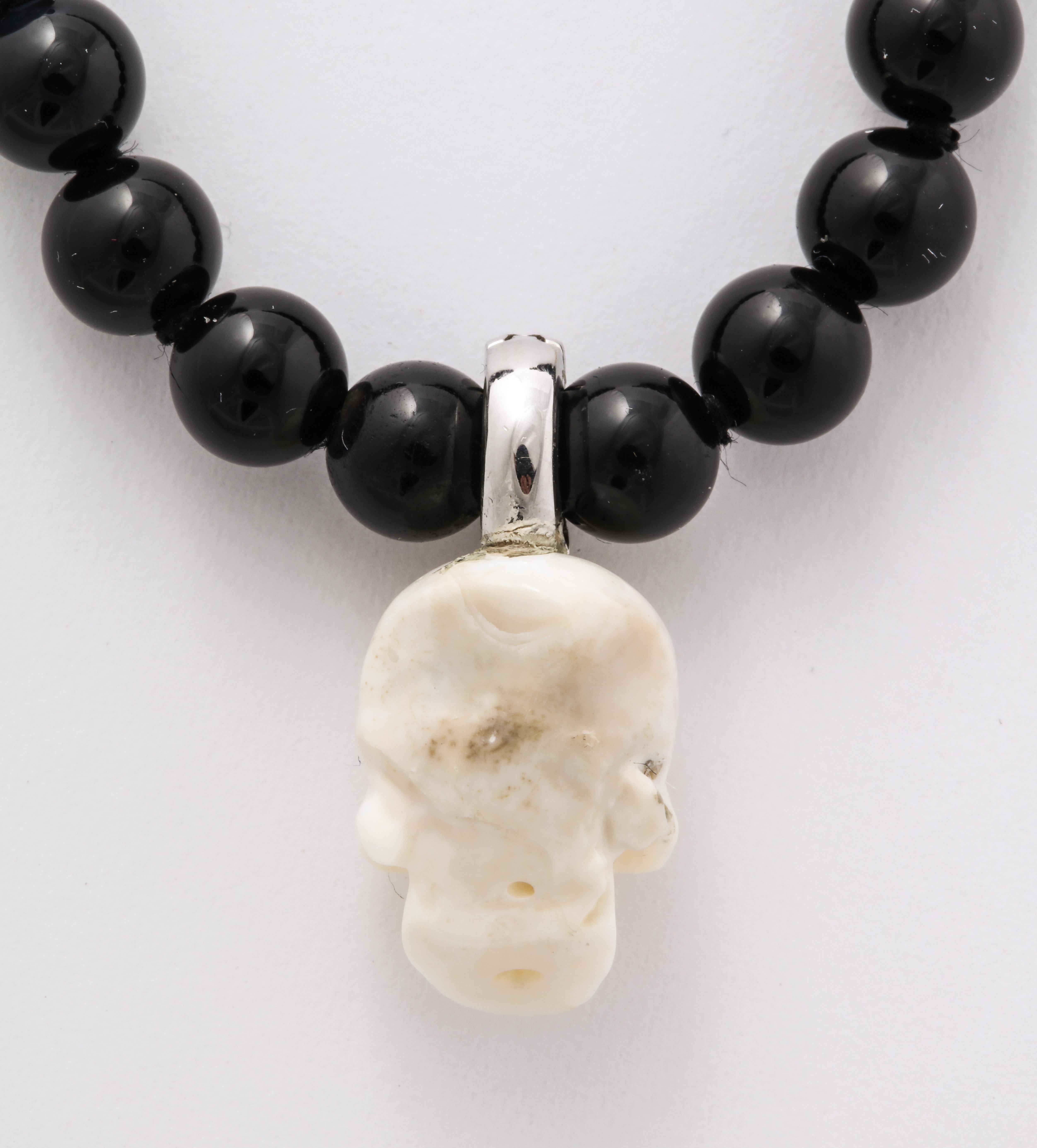 Contemporary Natural White Coral Carved Skull Paved Diamonds On Onyx Beads 18k Gold Clasp For Sale