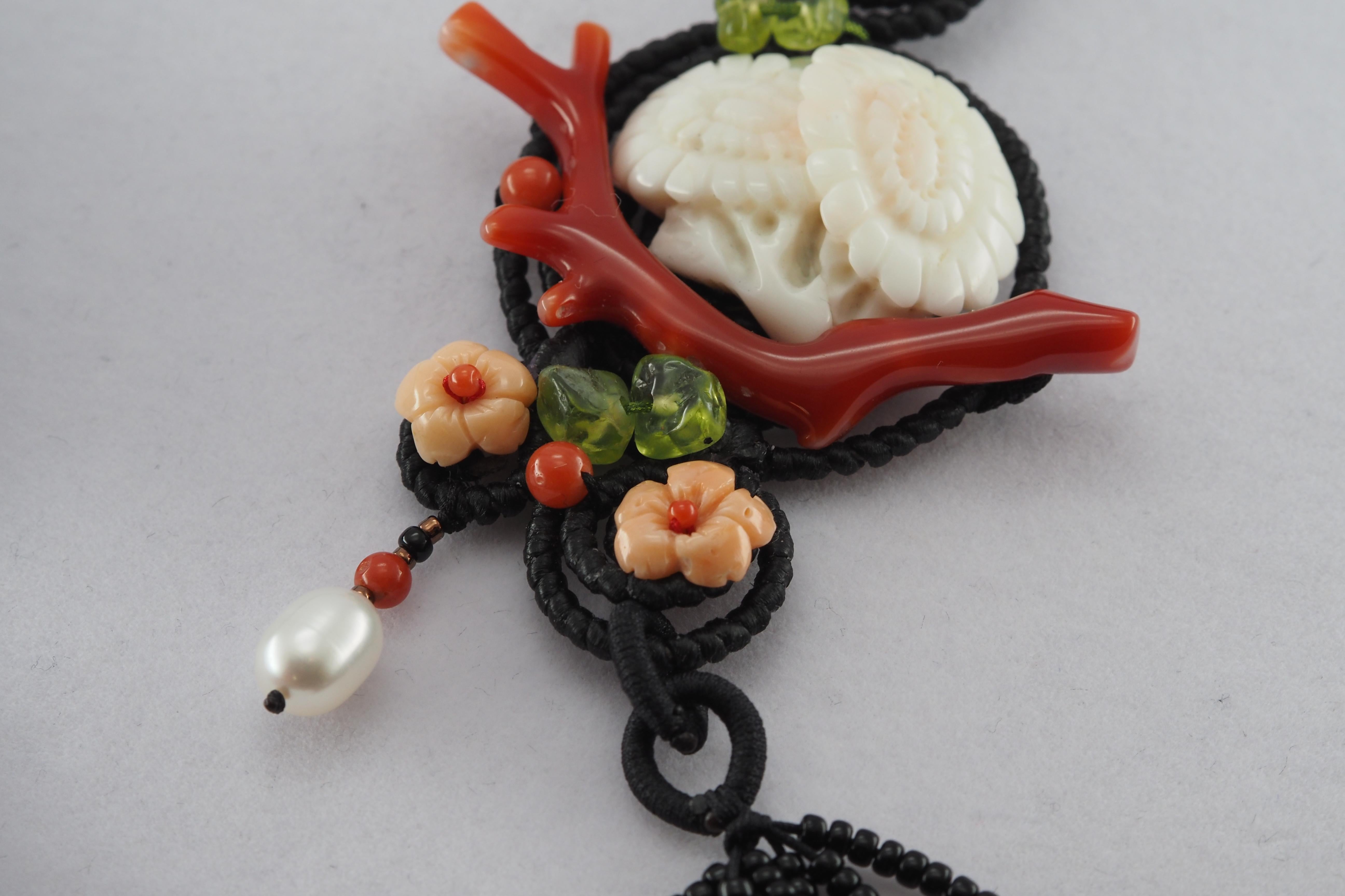 This design features natural white coral carved into the shape of chrysanthemums, symbolizing loyalty and honesty. The piece is enhanced with natural pink coral carved into roses, representing love and passion. Beneath the chrysanthemums lies a