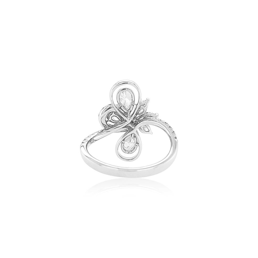 This sumptuous Platinum ring features Pear-shape White diamonds set amongst scintillating Marquise-shape White diamonds and swirls surrounding them. This unique and striking ring will make the perfect statement each time it is worn.
-	Pear Shape