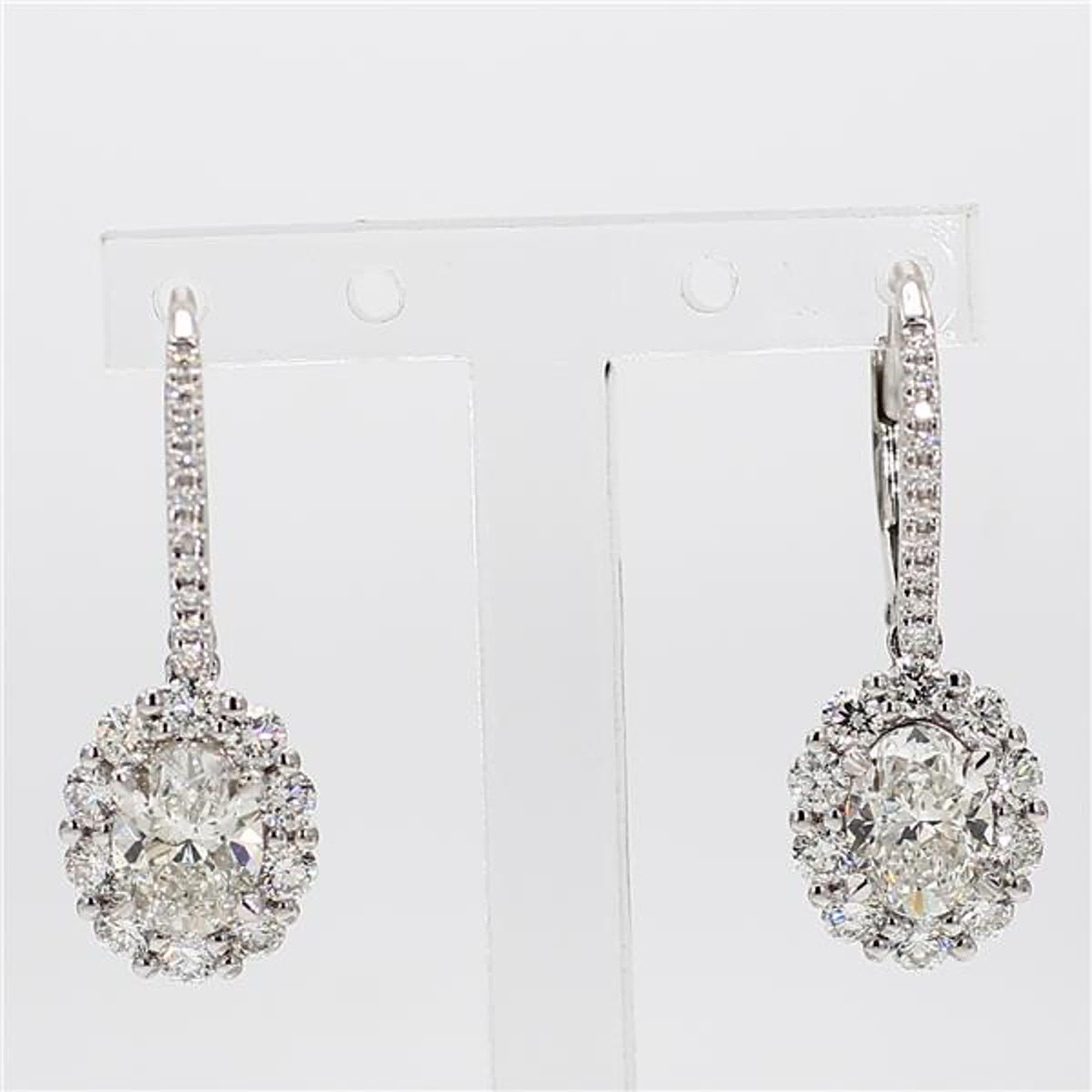 RareGemWorld's classic diamond earrings. Mounted in a beautiful 18K White Gold setting with natural oval cut white diamonds surrounded by natural round cut white diamonds. These earrings are guaranteed to impress and enhance your personal