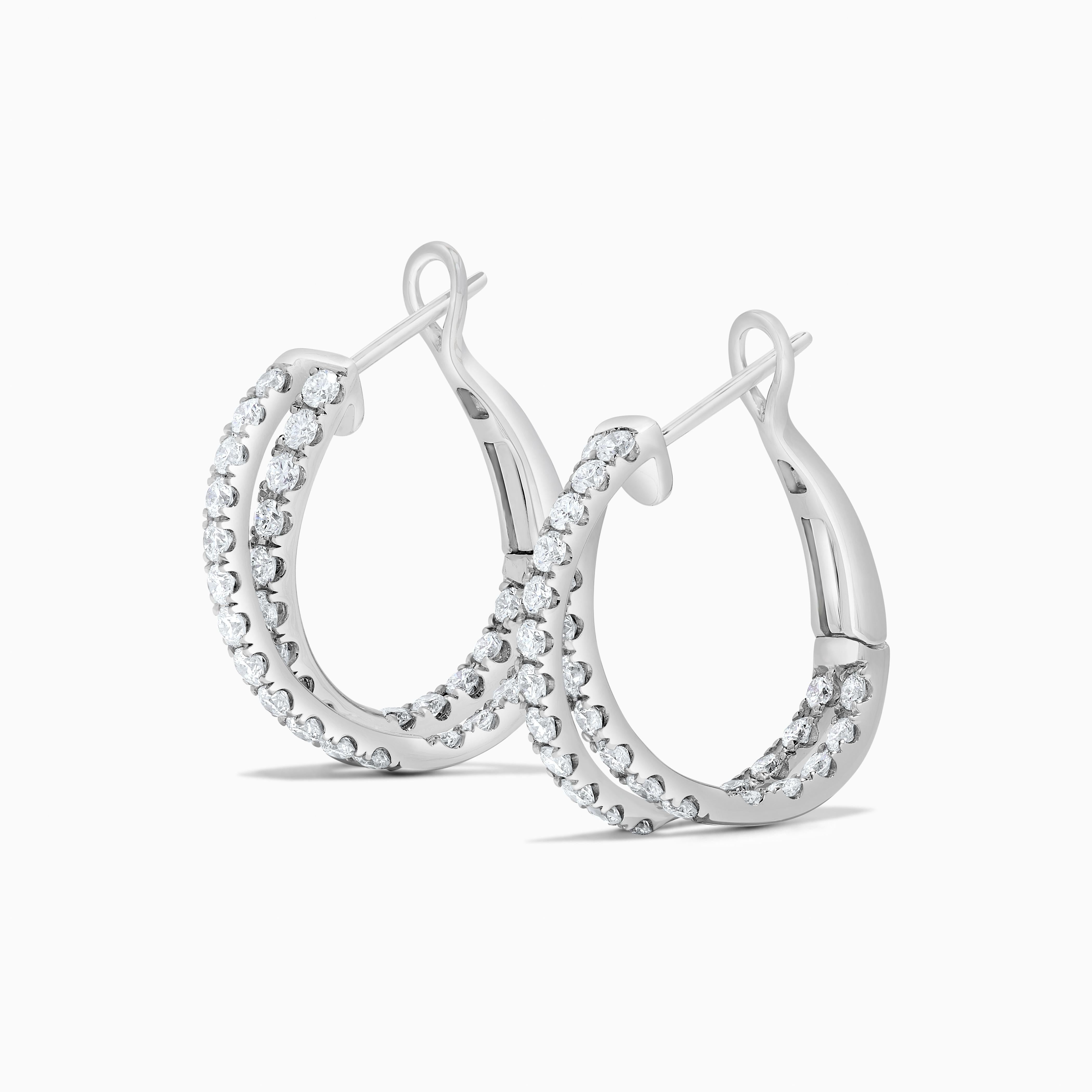 RareGemWorld's classic diamond earrings. Mounted in a beautiful 18K White Gold setting with natural round cut white diamonds in a beautiful interlocking circle form. These earrings are guaranteed to impress and enhance your personal