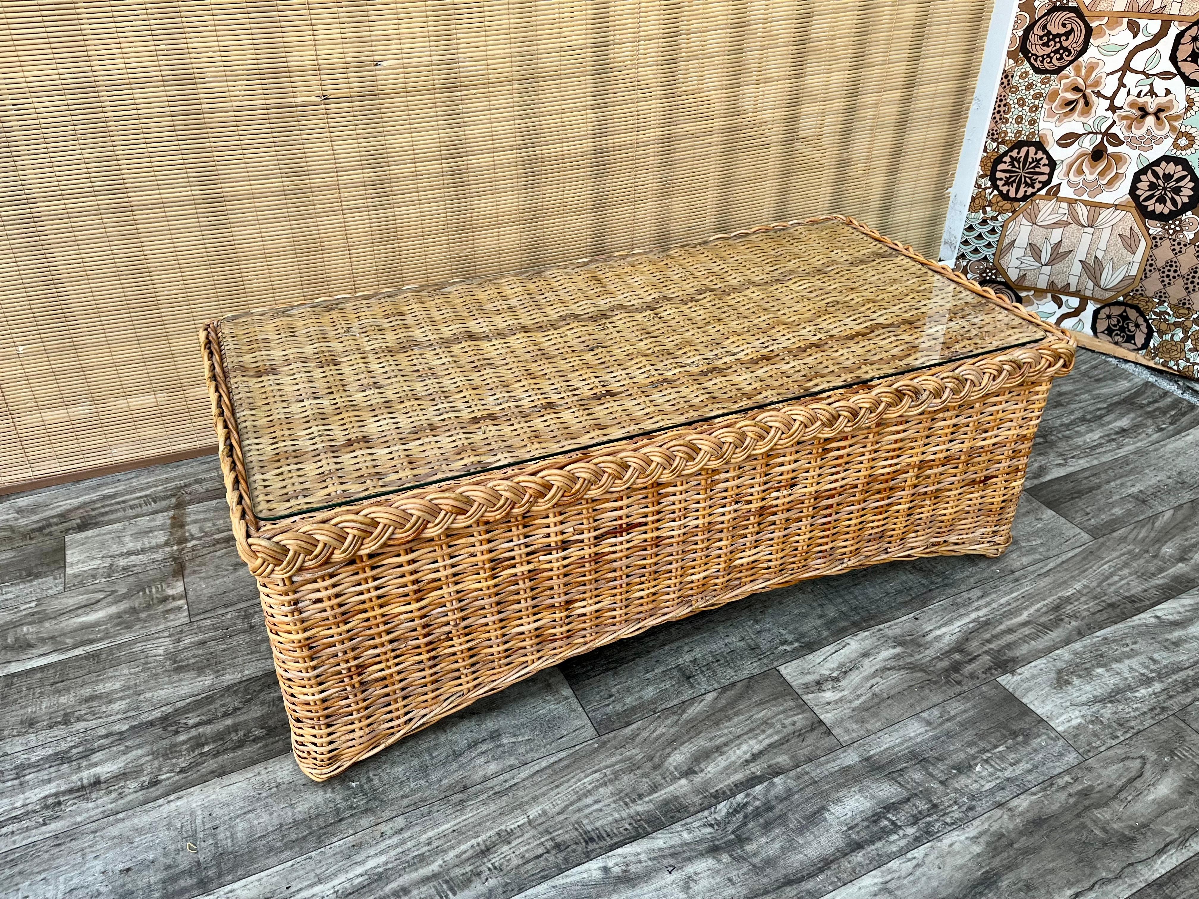  Vintage Large Scale, Natural Wicker/Rattan Coastal Style Coffee Table in the Bielecky Brothers' manner. Circa 1970s
Features a beautiful glowing honey colored weaved rattan frame with an elegant braided trim detail at top edges, with a removable