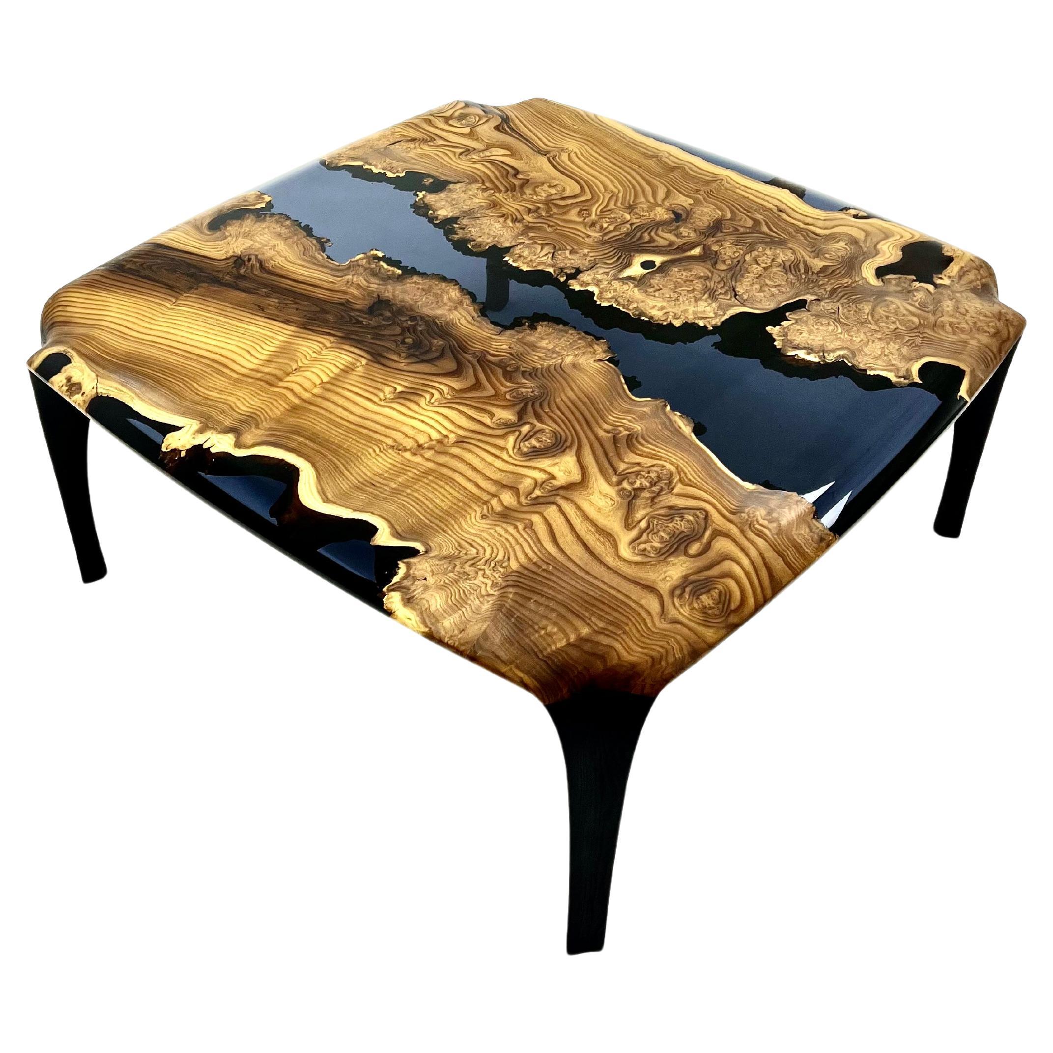 Epoxy Coffee Table

Handcrafted by skilled artisans, this coffee table seamlessly fuses natural wood with smoke epoxy resin, creating a captivating piece that captures nature's beauty. 
Its exceptional design and craftsmanship make it a centerpiece