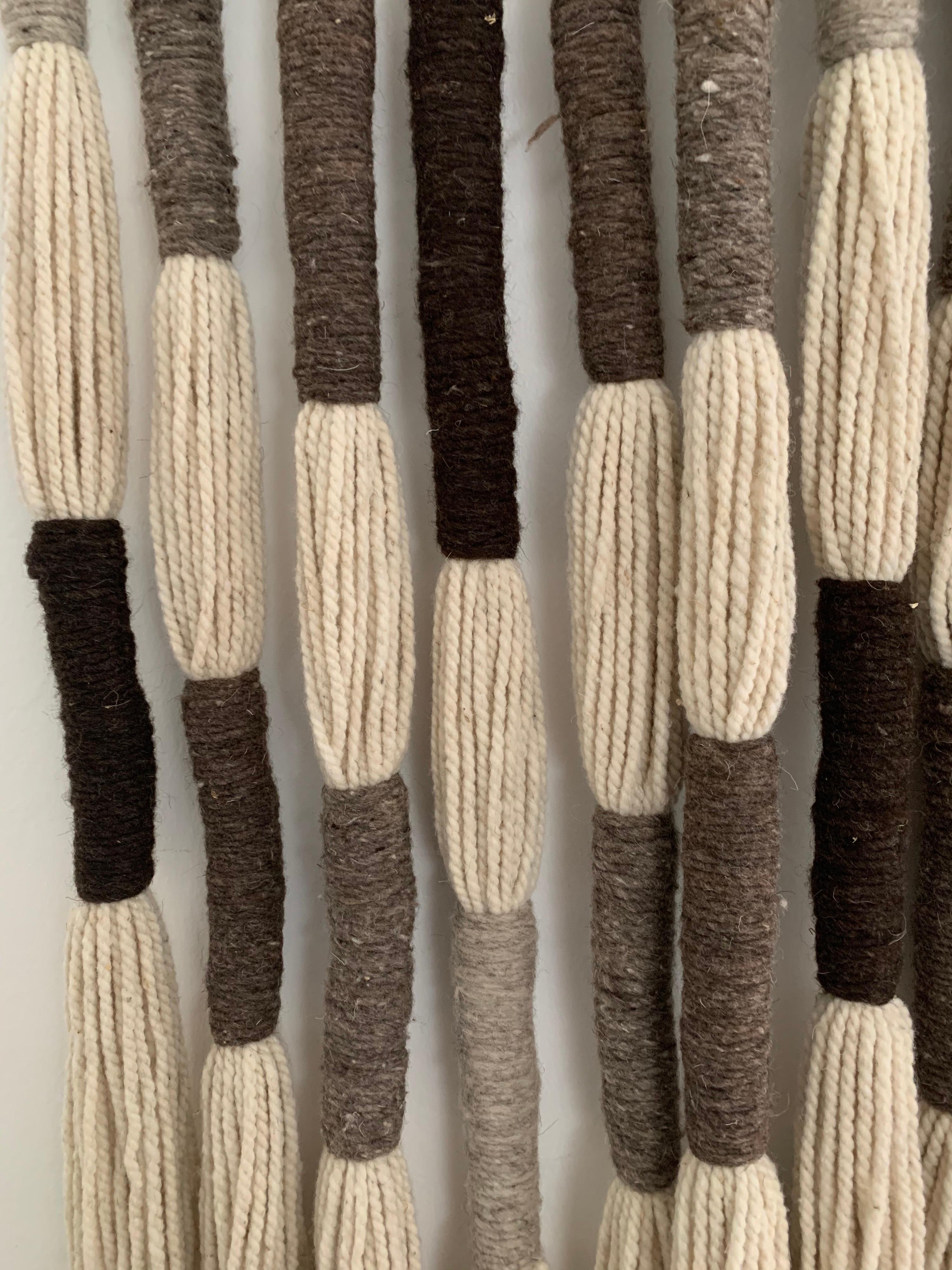 Reminiscent of Jane Knight's wall art in the 1960s, this is made from 100% natural died wools. This oversized wall hanging with earth tones (browns, greys and beige) is all hand made in a Mexican artist colony. The scale and ease of hanging is