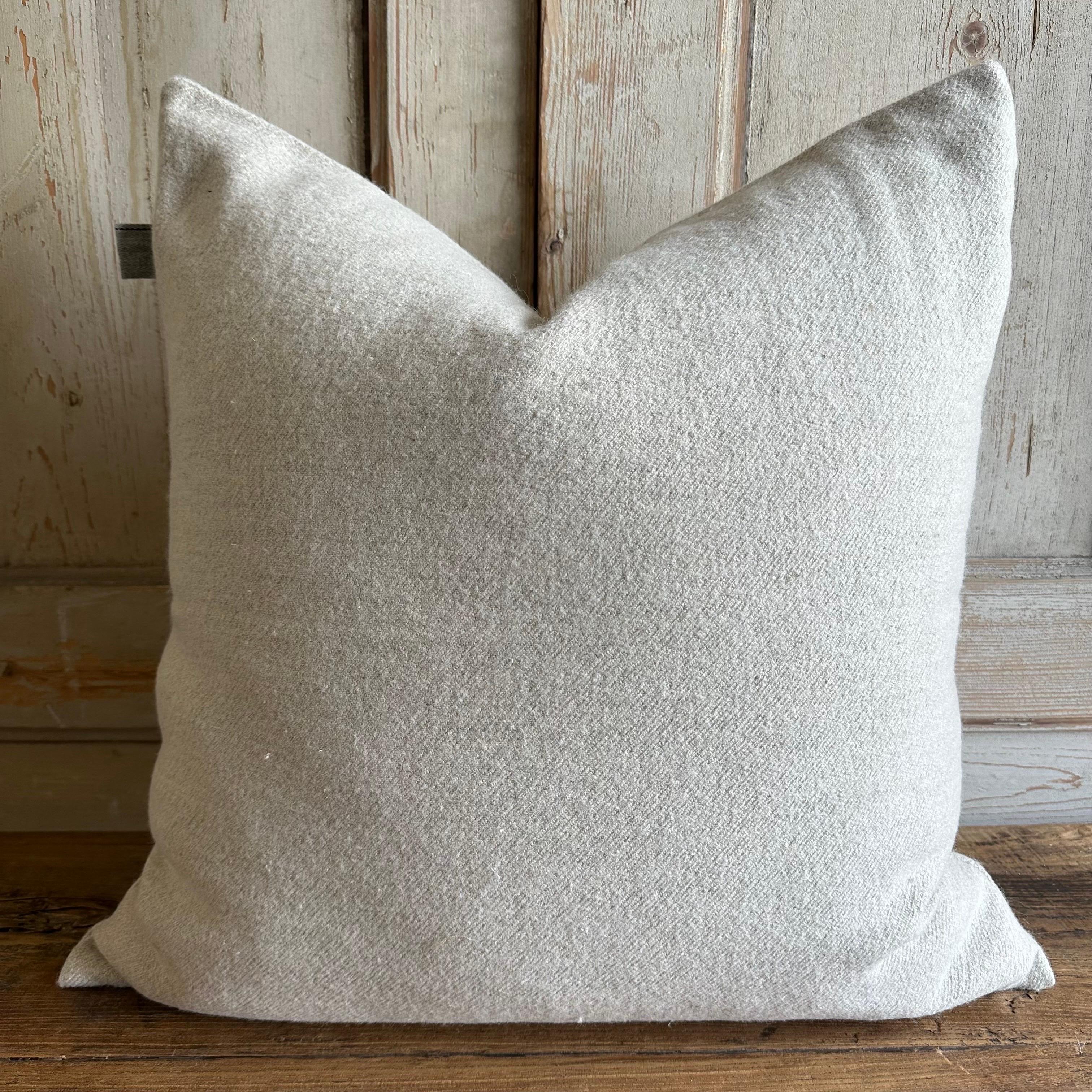 Oatmeal plush wool accent pillow 
Details: thick plush pile, soft to the touch
Color: oatmeal; the color or oatmeal, a greige, white with beige tones.
Size 24x24
Includes down feather insert
hidden zipper closure.