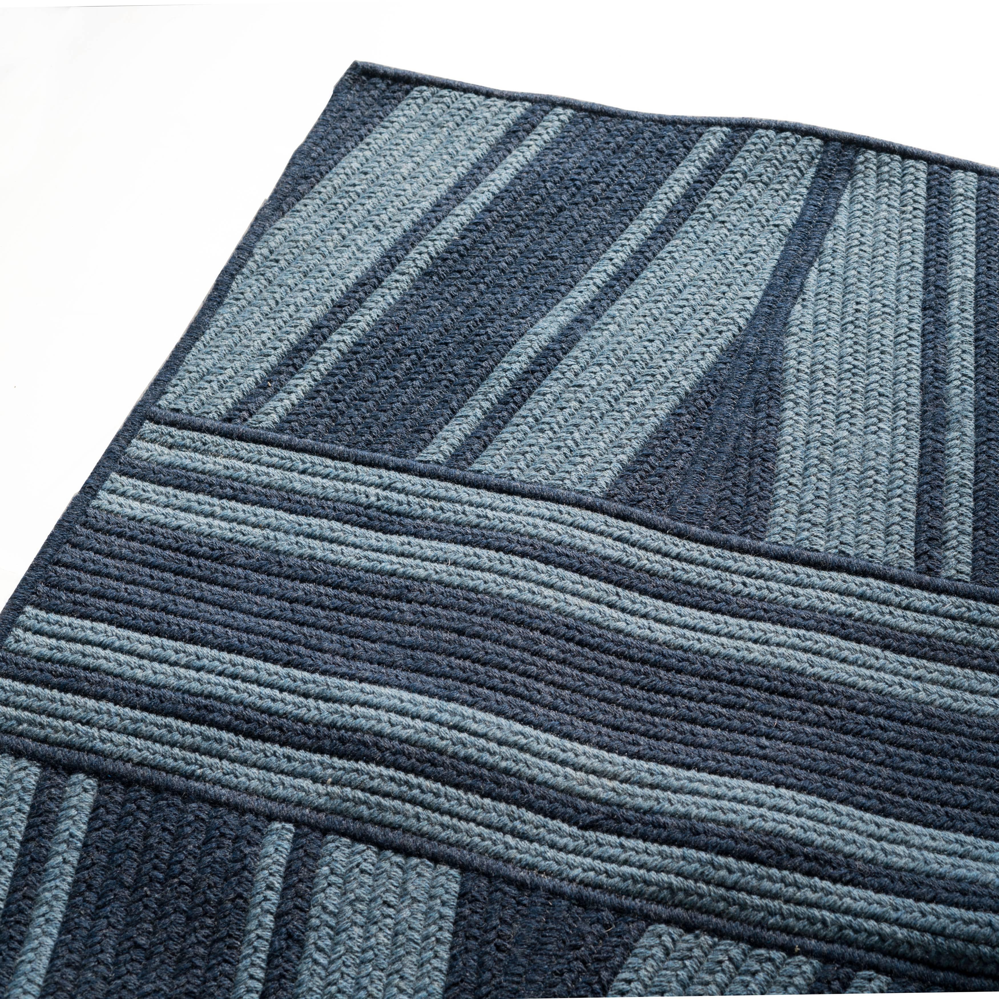 Studio navy wool blend geometric 8' x 10' rectangle Reversible rug. Angled lines and the use of blue and navy wool blend yarns, create a tonal pattern in our navy studio rug.  Designed in the Thayer Design Studio (Best of Houzz Design 2018), and