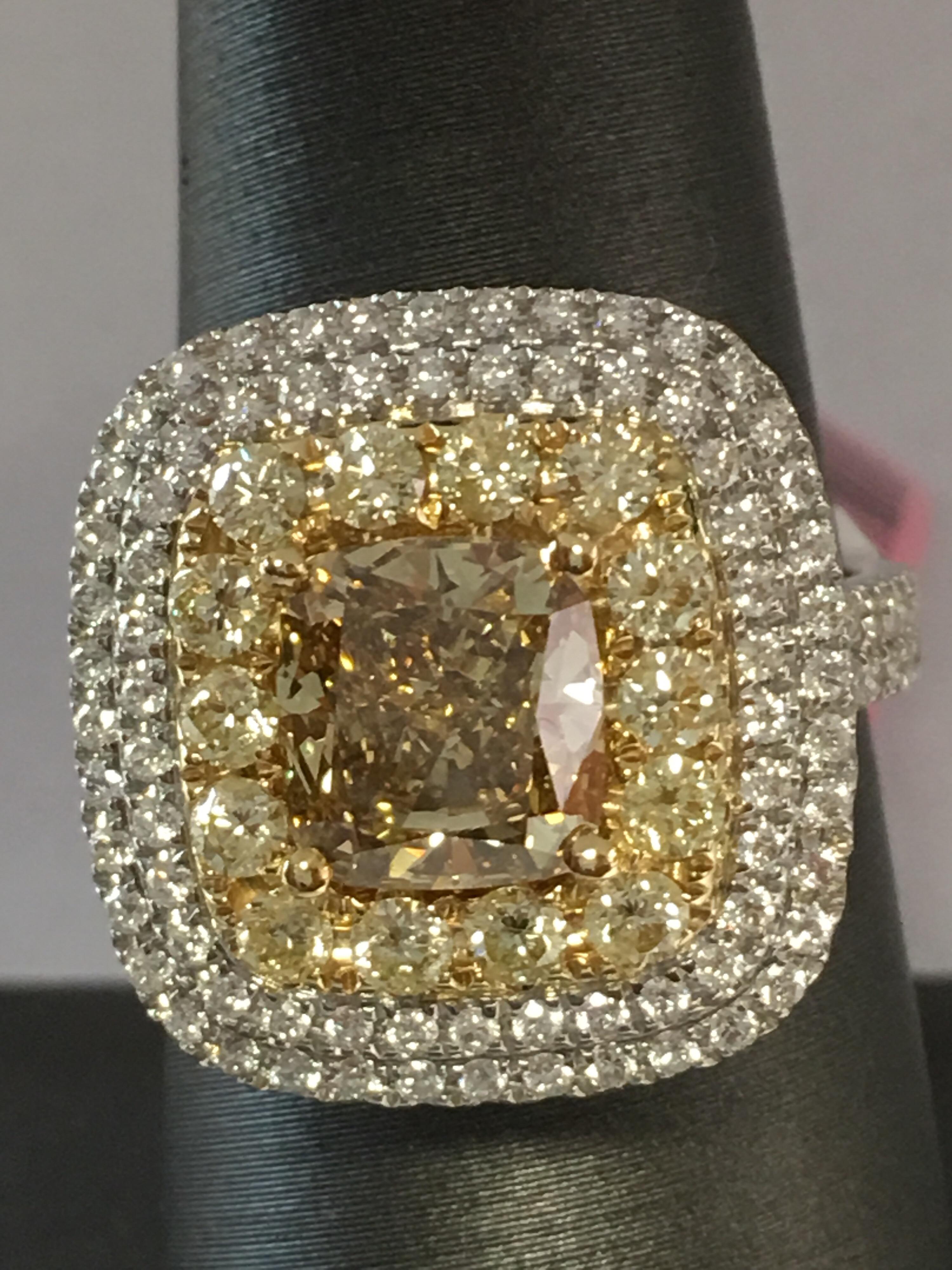 Center 2.21 CTS Cushion cut Yellow diamond and other halo yellow 14 pcs weigh 0.68 CTS and other white round diamonds weigh 2.66 CTS and total diamonds 5.55CTS set in 18K two tone gold. Now size is 7 but you can resize the ring in your local jewelry