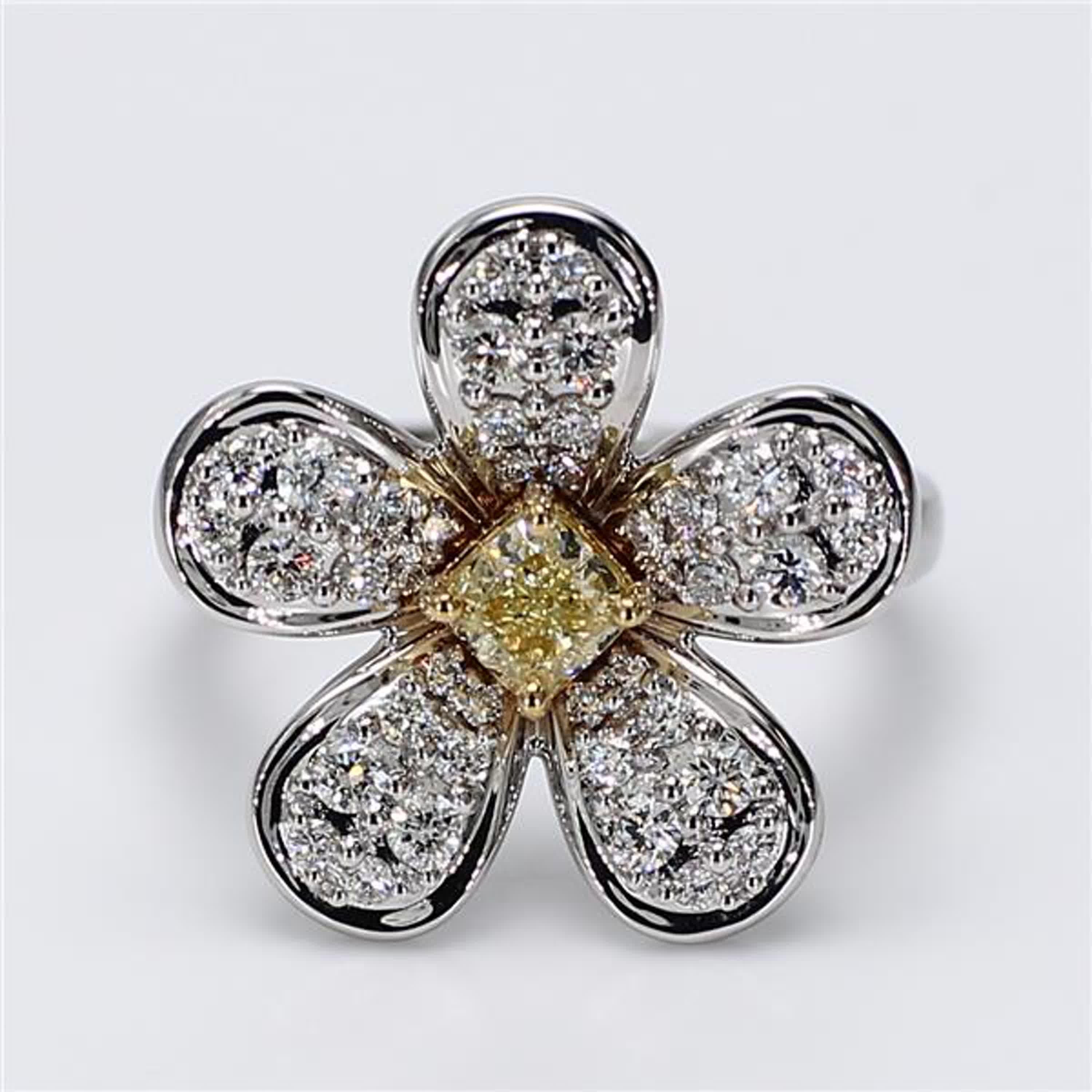 RareGemWorld's classic diamond ring. Mounted in a beautiful 18K Yellow and White Gold setting with a natural cushion cut yellow diamond. The yellow diamond is surrounded by small round natural white diamond melee. This ring is guaranteed to impress