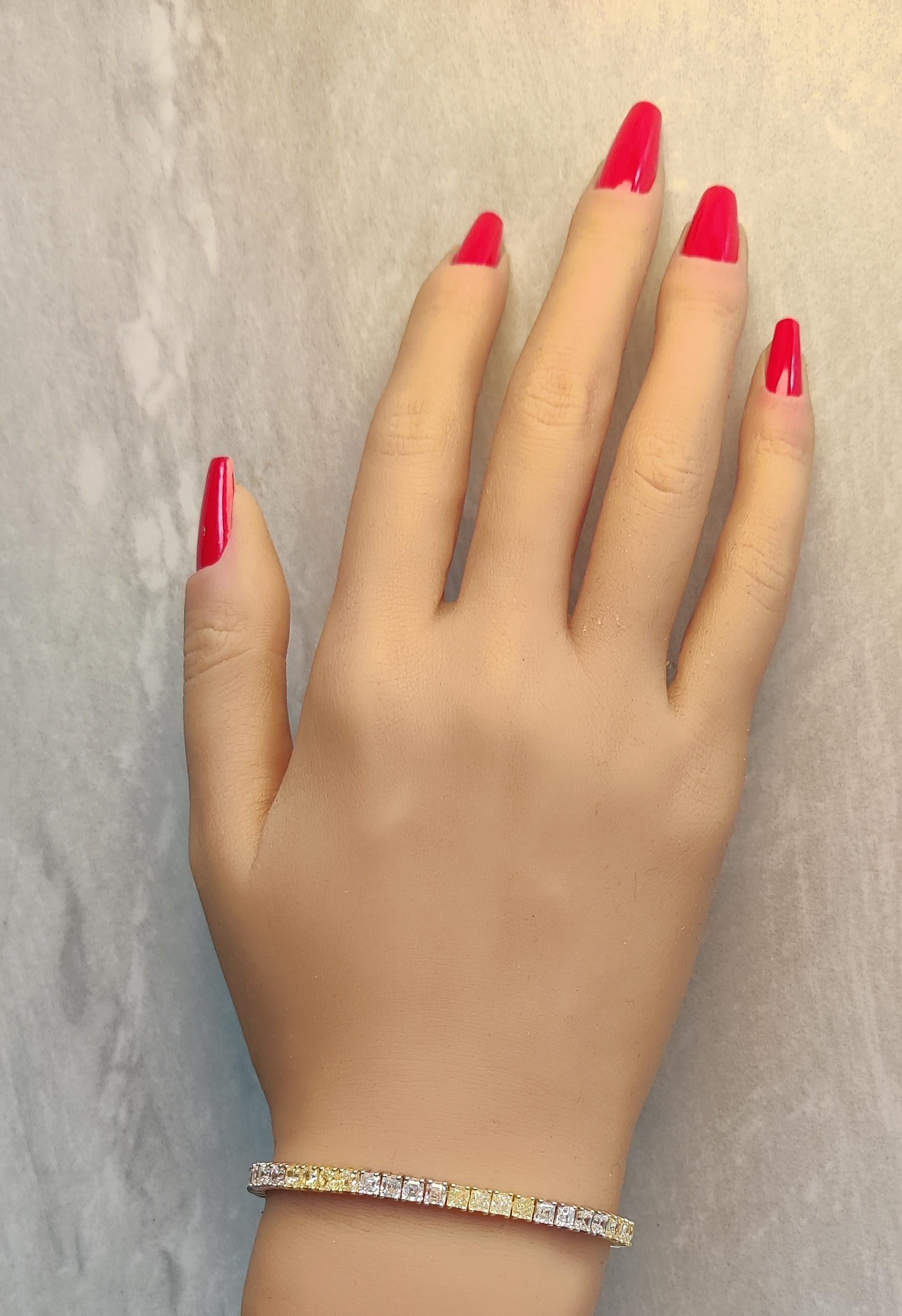 RareGemWorld's beautiful diamond bracelet. Mounted in a beautiful 18K Yellow and White Gold setting with natural cushion cut yellow diamonds. The yellow diamonds are complimented by natural asscher cut white diamonds. This bracelet is guaranteed to