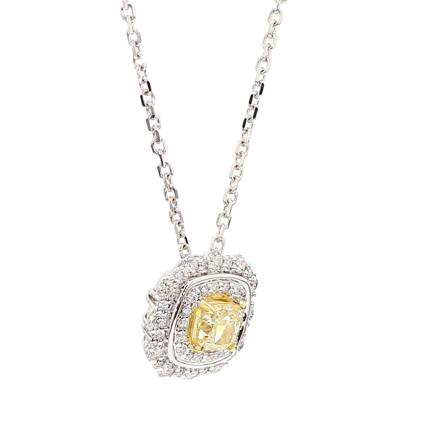RareGemWorld's intriguing diamond pendant. Mounted in a beautiful 18K Yellow and White Gold setting with a natural cushion cut yellow diamond. The yellow diamond is surrounded by small round natural white diamond melee. This pendant is guaranteed to