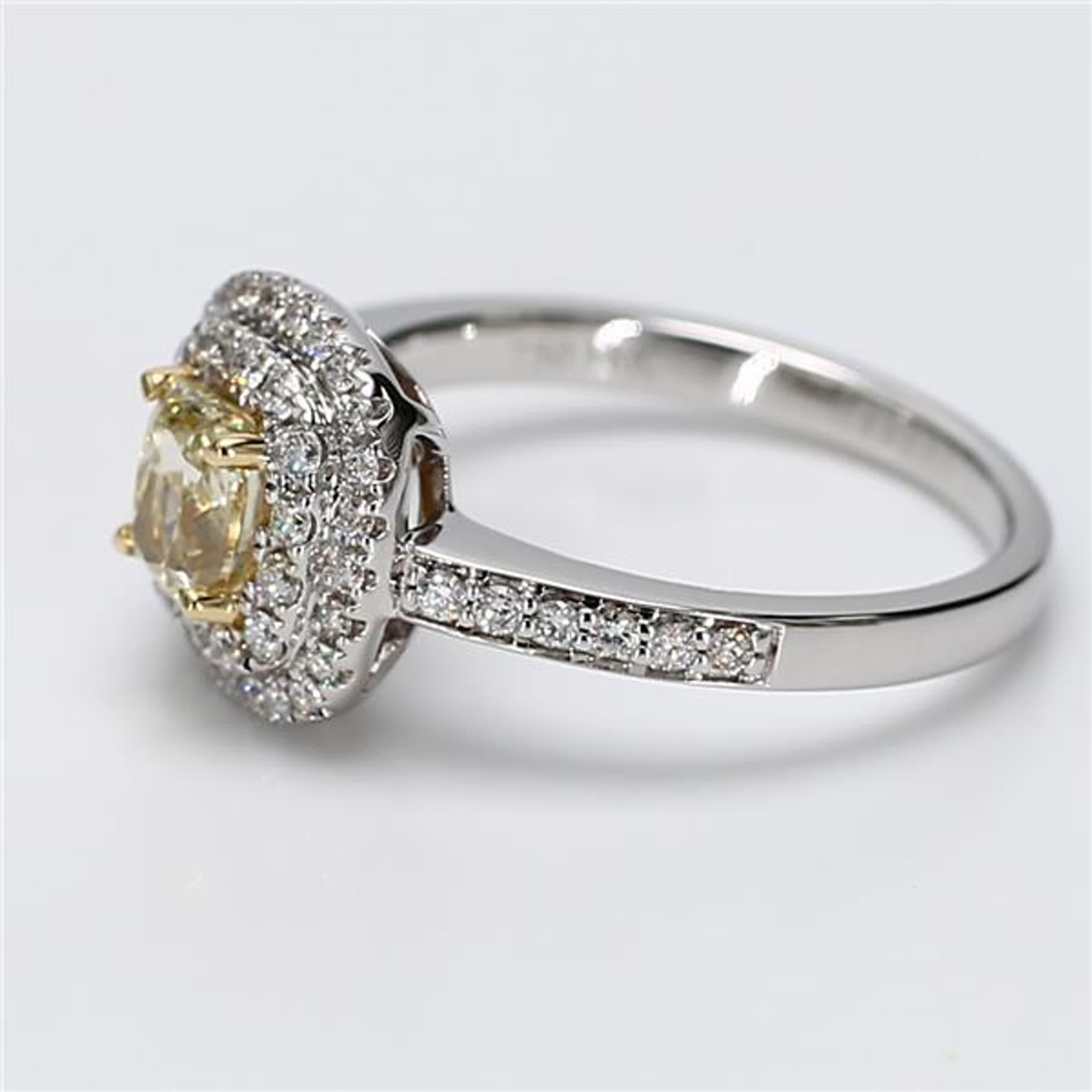 RareGemWorld's classic diamond ring. Mounted in a beautiful 18K Yellow and White Gold setting with a natural cushion cut yellow diamond. The yellow diamond is surrounded by round natural white diamond melee. This ring is guaranteed to impress and