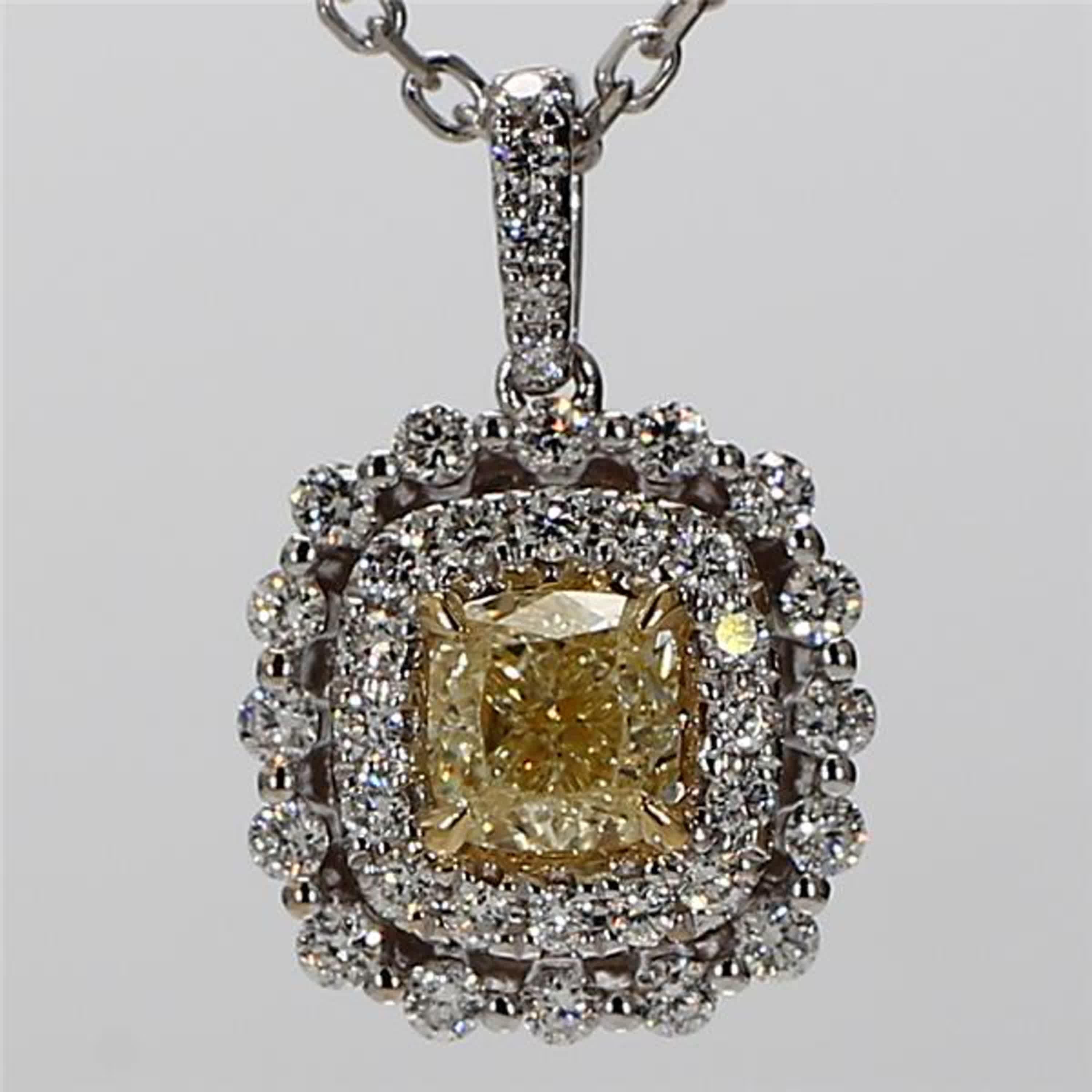 RareGemWorld's intriguing diamond pendant. Mounted in a beautiful 18K Yellow and White Gold setting with a natural cushion cut yellow diamond. The yellow diamond is surrounded by small round natural white diamond melee. This pendant is guaranteed to