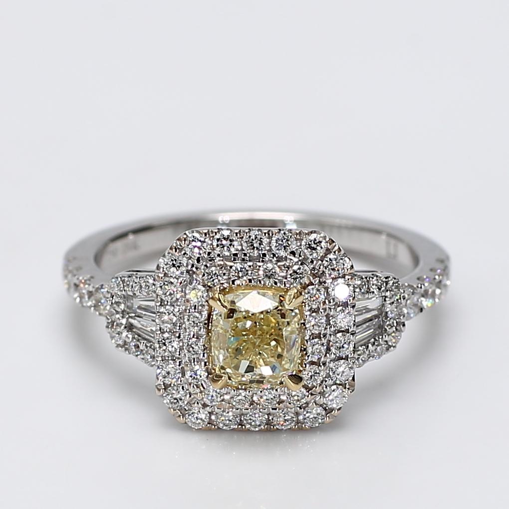 RareGemWorld's classic diamond ring. Mounted in a beautiful 18K Yellow and White Gold setting with a natural cushion cut yellow diamond. The yellow diamond is surrounded by natural round white diamond melee and natural white diamond baguettes. This