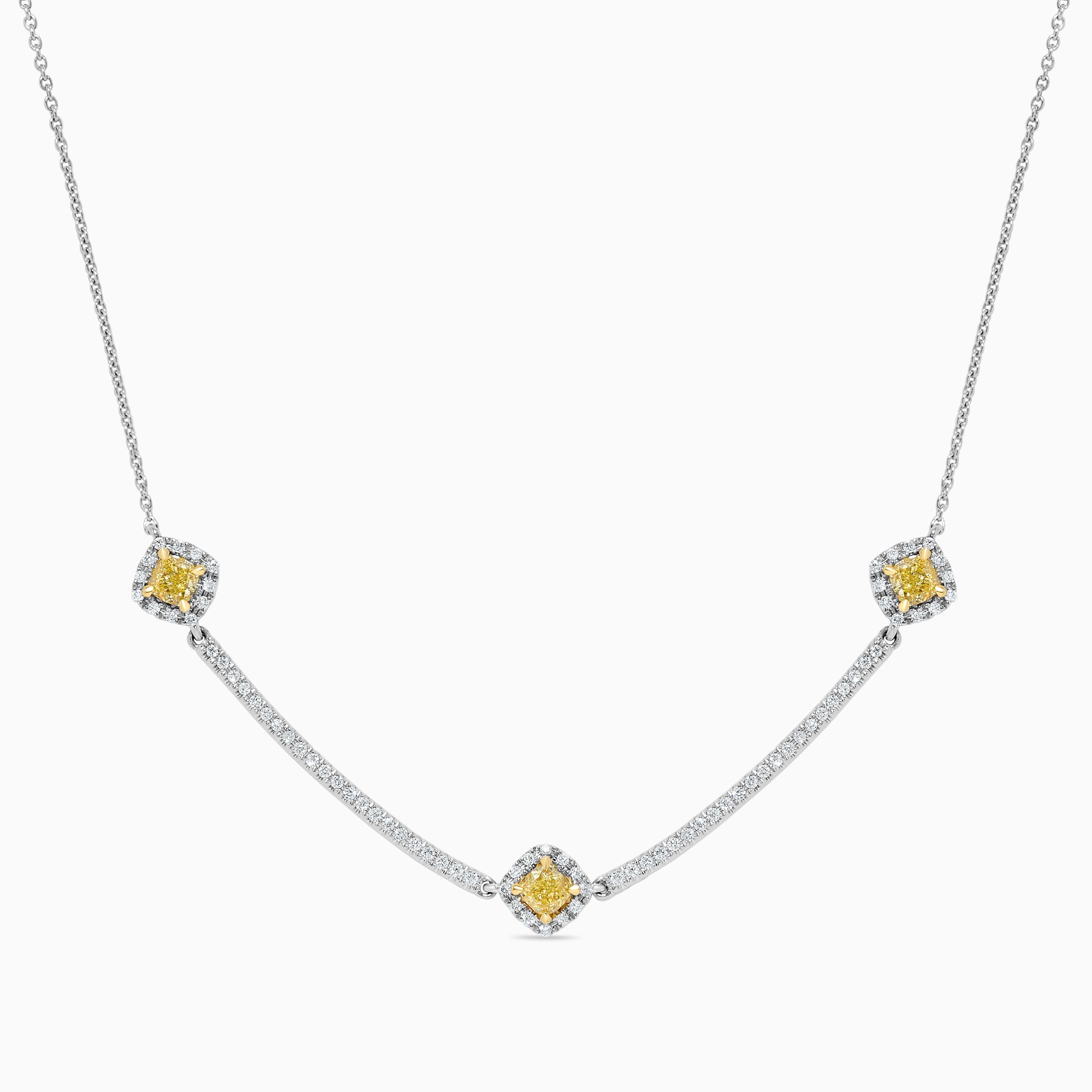 RareGemWorld's classic diamond necklace. Mounted in a beautiful 18K Yellow and White Gold setting with a natural cushion cut yellow diamond. The yellow diamond is surrounded by small round natural white diamond melee as well as diamonds throughout