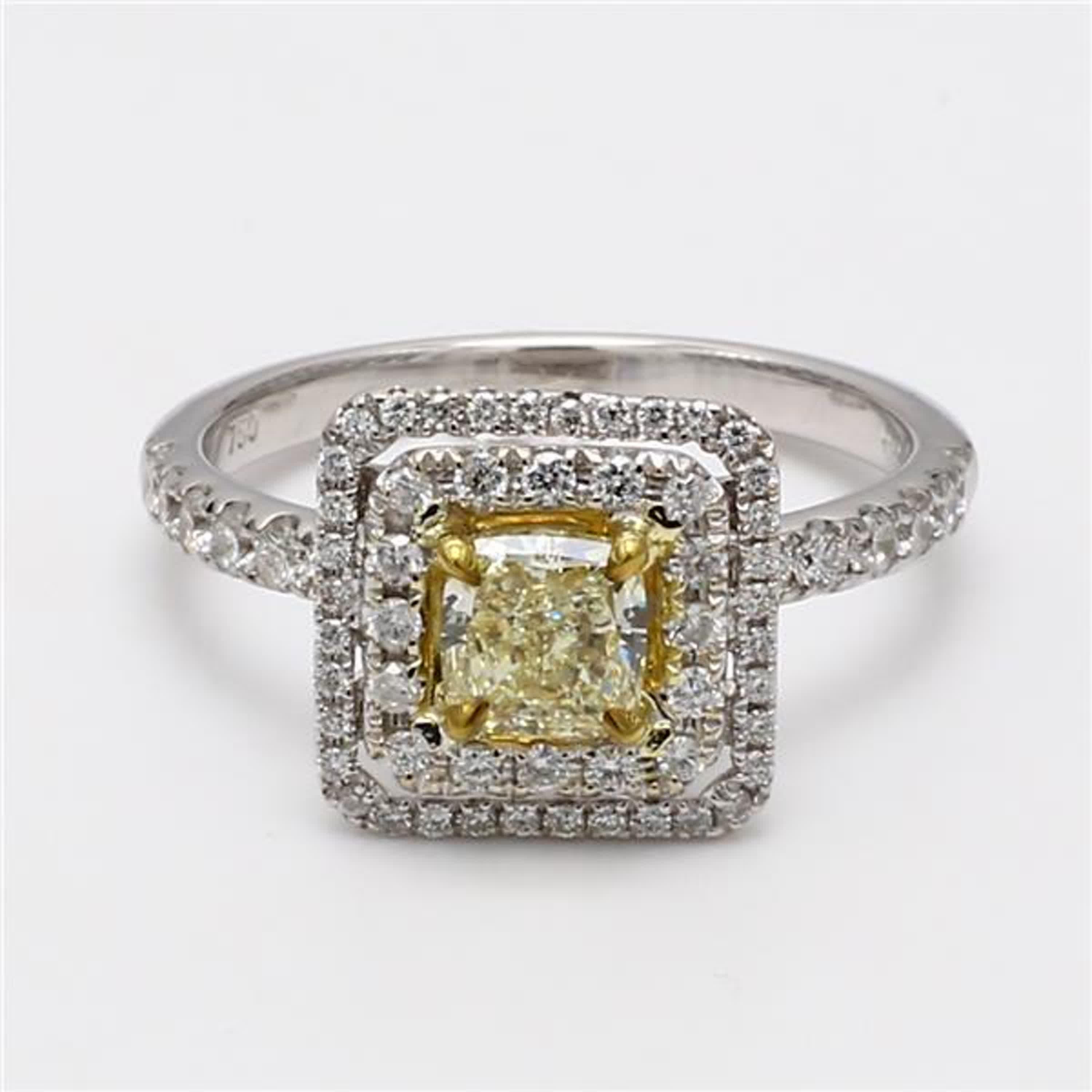 RareGemWorld's classic diamond ring. Mounted in a beautiful 18K Yellow and White Gold setting with a natural cushion cut yellow diamond. The yellow diamond is surrounded by round natural white diamond melee. This ring is guaranteed to impress and