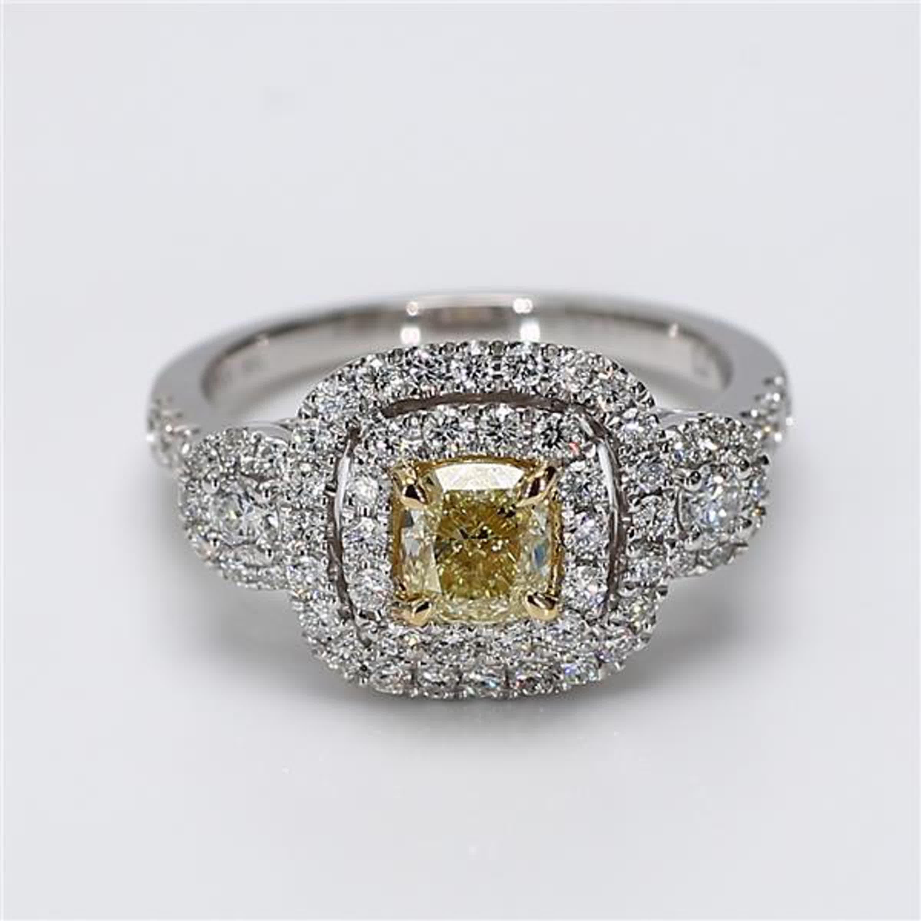 RareGemWorld's classic diamond ring. Mounted in a beautiful Platinum/18K Yellow and White Gold setting with a natural cushion cut yellow diamond. The yellow diamond is surrounded by round natural white diamond melee. This ring is guaranteed to