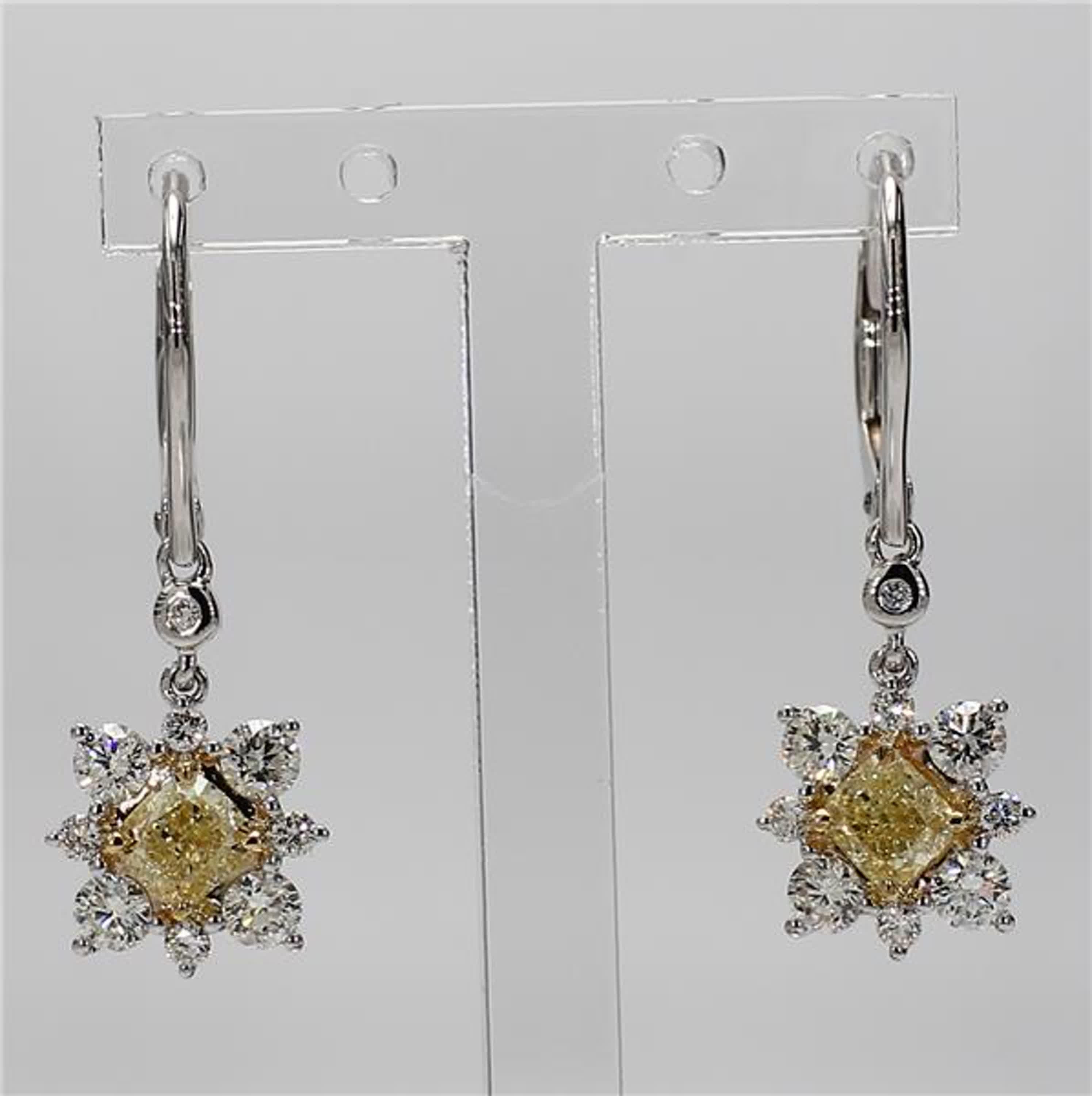 RareGemWorld's classic diamond earrings. Mounted in a beautiful 18K Yellow and White Gold setting with natural cushion cut yellow diamonds. The yellow diamonds are surrounded by small round natural white diamond melee. These earrings are guaranteed