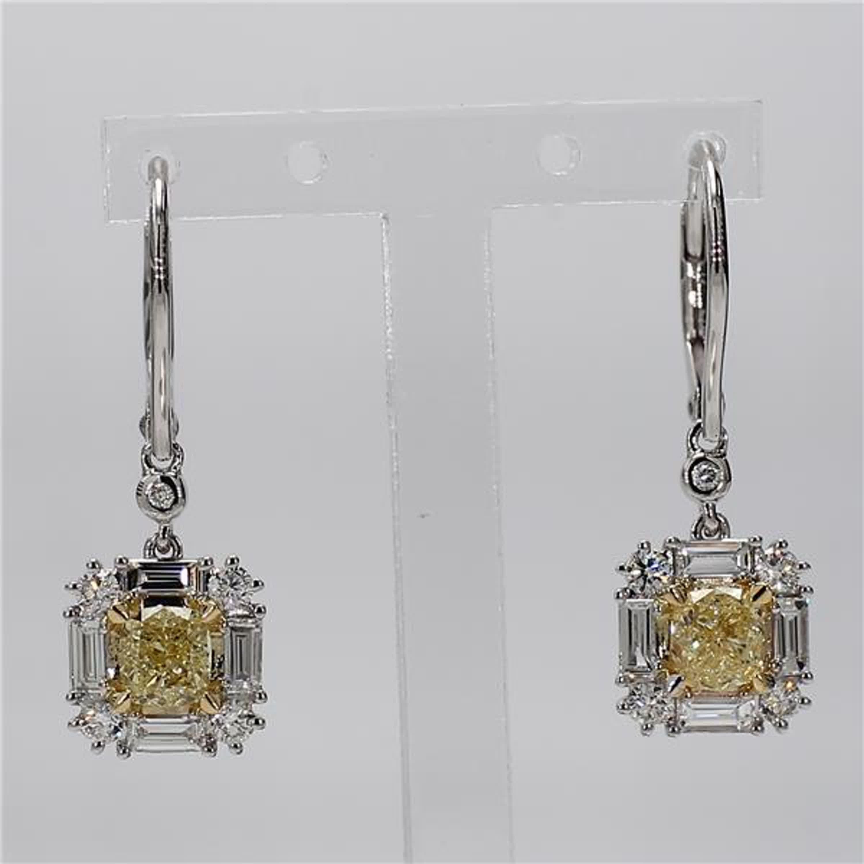 RareGemWorld's classic diamond earrings. Mounted in a beautiful 18K Yellow and White Gold setting with natural cushion cut yellow diamonds. The yellow diamonds are surrounded by small round natural white diamond melee as well as natural white