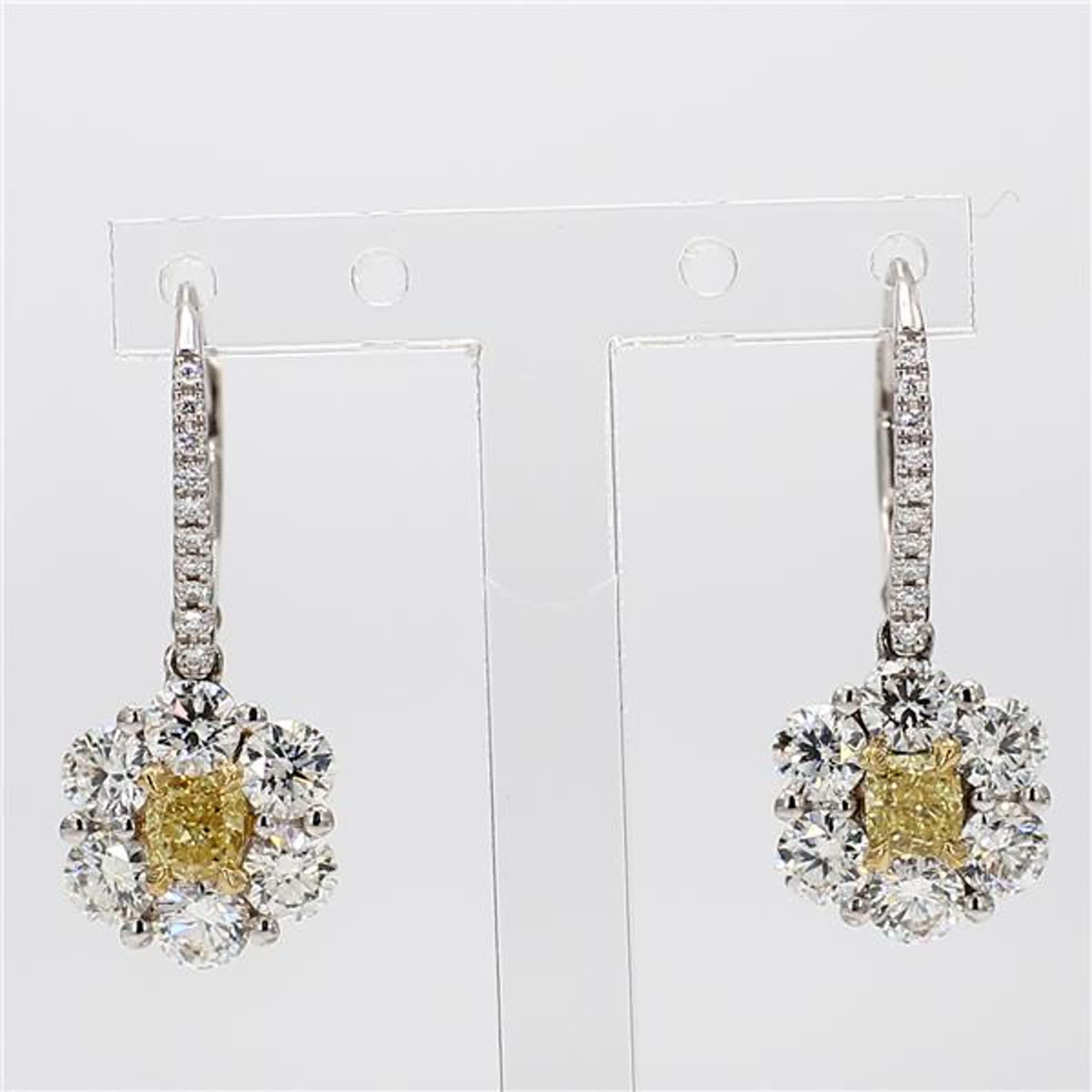 RareGemWorld's classic diamond earrings. Mounted in a beautiful 18K Yellow and White Gold setting with natural cushion cut yellow diamonds. The yellow diamonds are surrounded by large round natural white diamond melee as well as diamonds throughout
