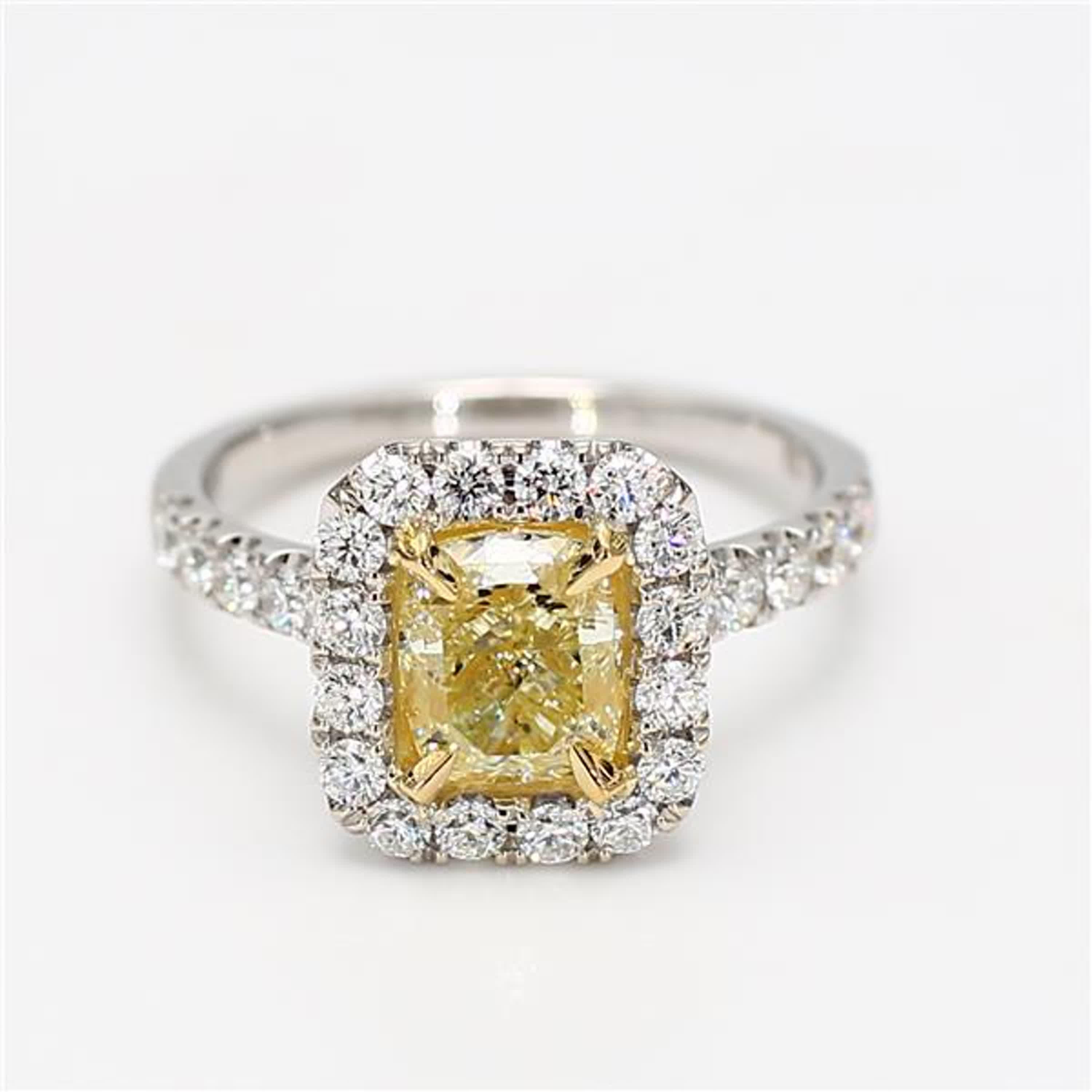 RareGemWorld's classic diamond ring. Mounted in a beautiful 18K Yellow and White Gold setting with a natural cushion cut yellow diamond. The yellow diamond is surrounded by small round natural white diamond melee. This ring is guaranteed to impress