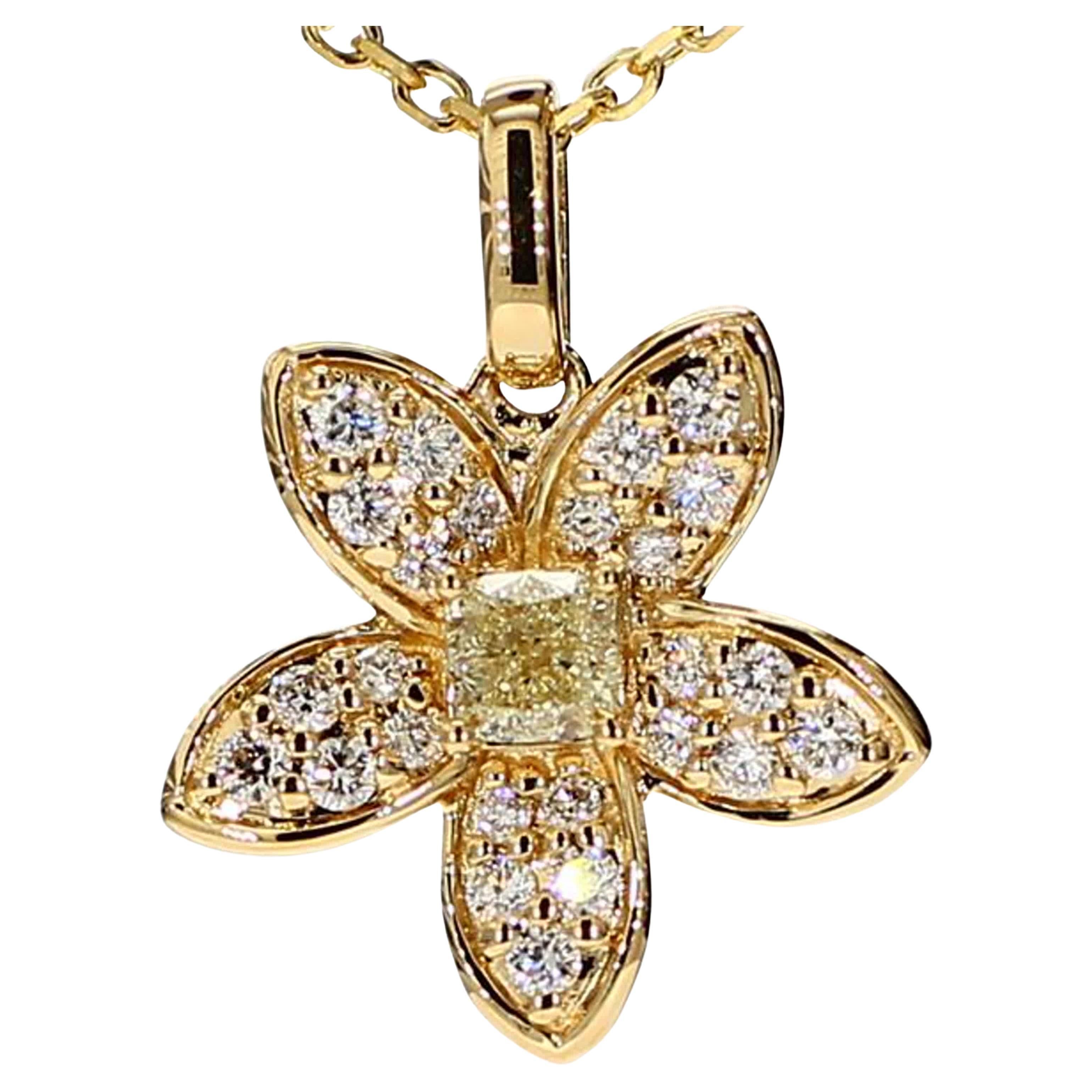 RareGemWorld's intriguing diamond pendant. Mounted in a beautiful 18K Yellow Gold setting with a natural cushion cut yellow diamond. The yellow diamond is surrounded by small round natural white diamond melee in a beautiful flower shape. This