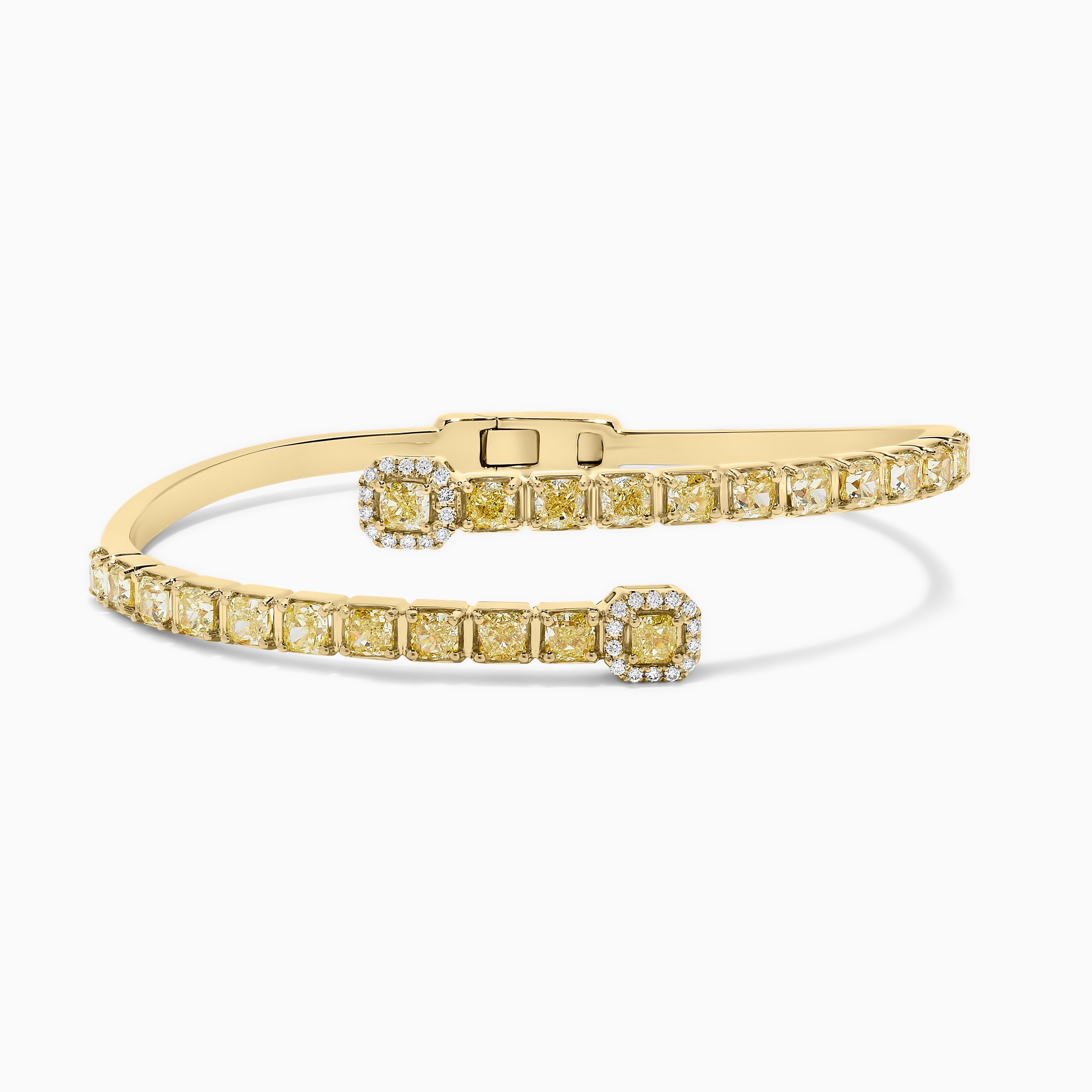 RareGemWorld's classic diamond bracelet. Mounted in a beautiful 18K Yellow Gold setting with natural cushion cut yellow diamonds. The yellow diamonds are surrounded by small round natural white diamond melee. This bracelet is guaranteed to impress!