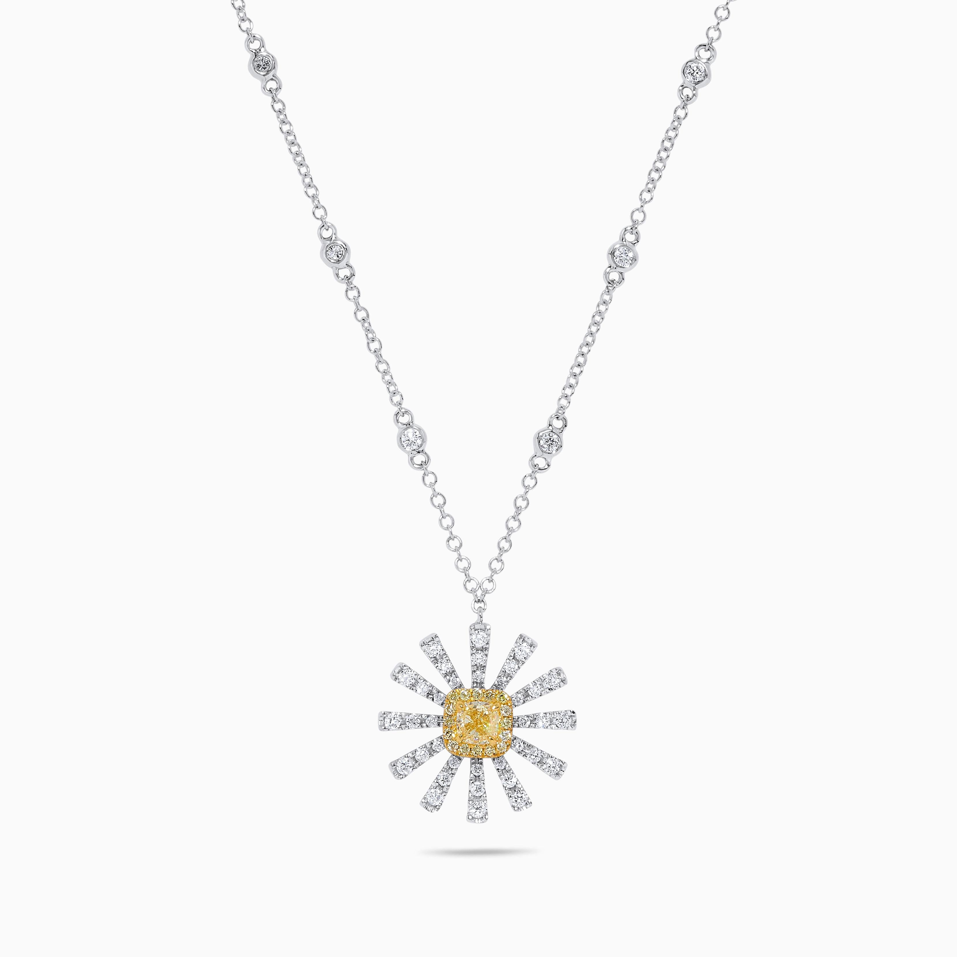 RareGemWorld's intriguing diamond pendant. Mounted in a beautiful 18K Yellow and White Gold setting with a natural cushion cut yellow diamond. The yellow diamond is surrounded by round natural yellow diamond melee and round natural white diamond