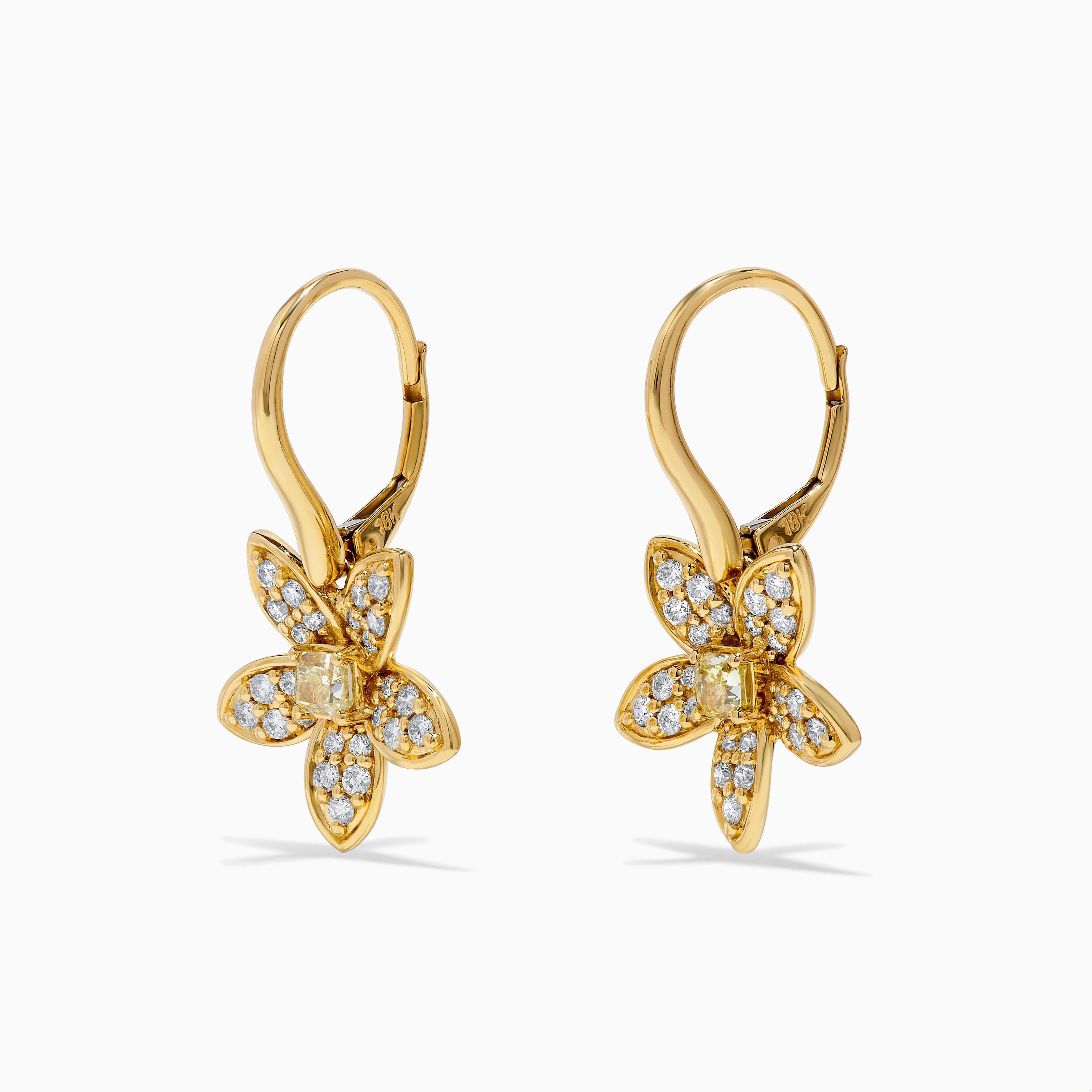 RareGemWorld's beautiful diamond earrings. Mounted in a beautiful 18K Yellow Gold setting with natural cushion cut yellow diamonds. The yellow diamonds are surrounded by small round natural white diamond melee in a beautiful flower form. These