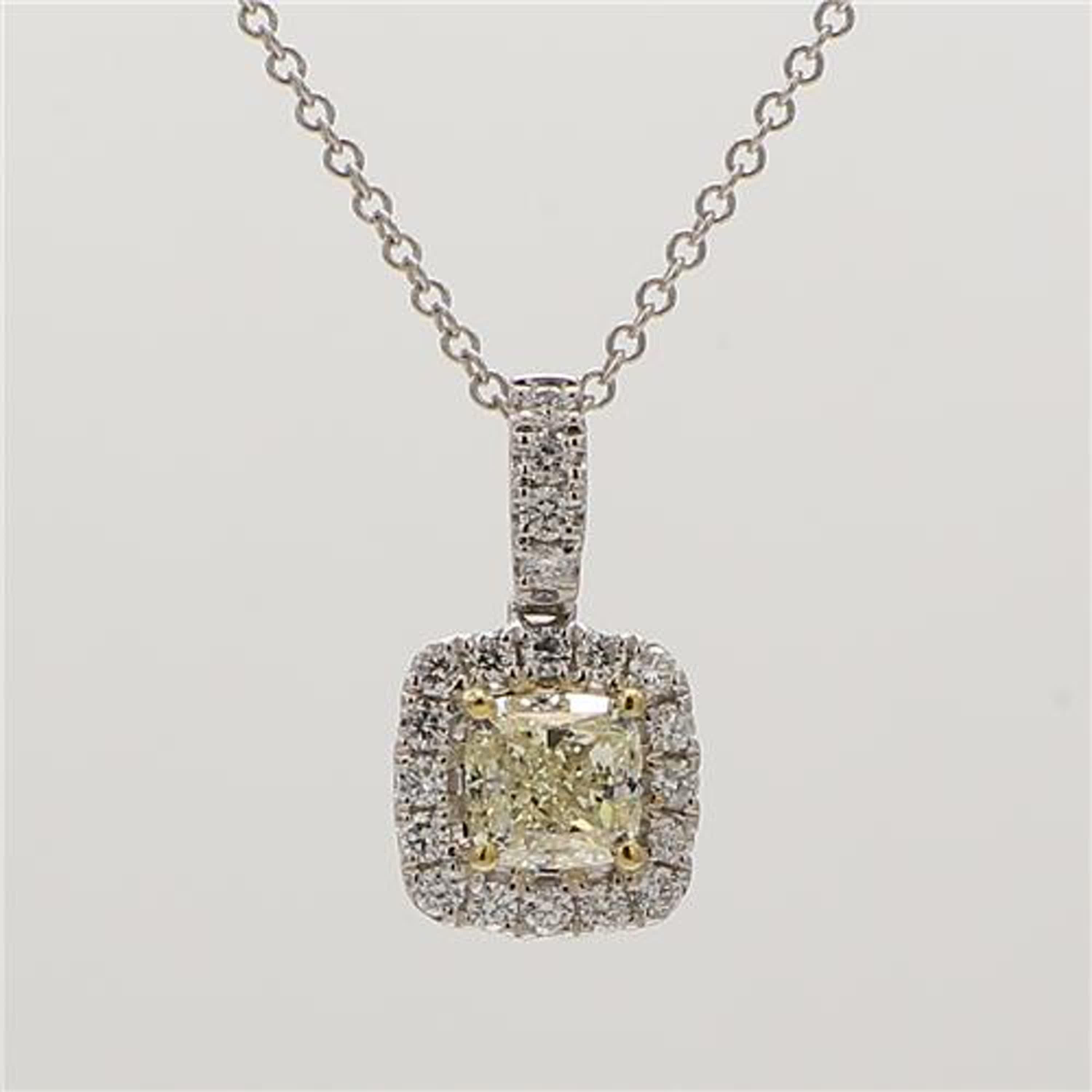 RareGemWorld's classic diamond pendant. Mounted in a beautiful 18K Yellow and White Gold setting with a natural cushion cut yellow diamond. The yellow diamond is surrounded by small round natural white diamond melee. This pendant is guaranteed to