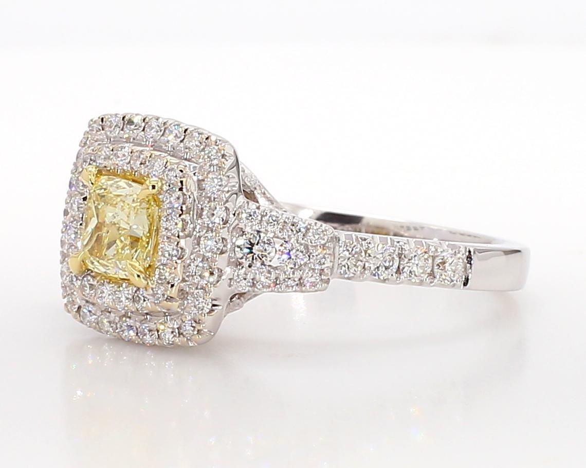 RareGemWorld's classic diamond ring. Mounted in a beautiful 18K Yellow and White Gold setting with a natural cushion cut yellow diamond. The yellow diamond is surrounded by round natural white diamond melee. This ring is guaranteed to impress and