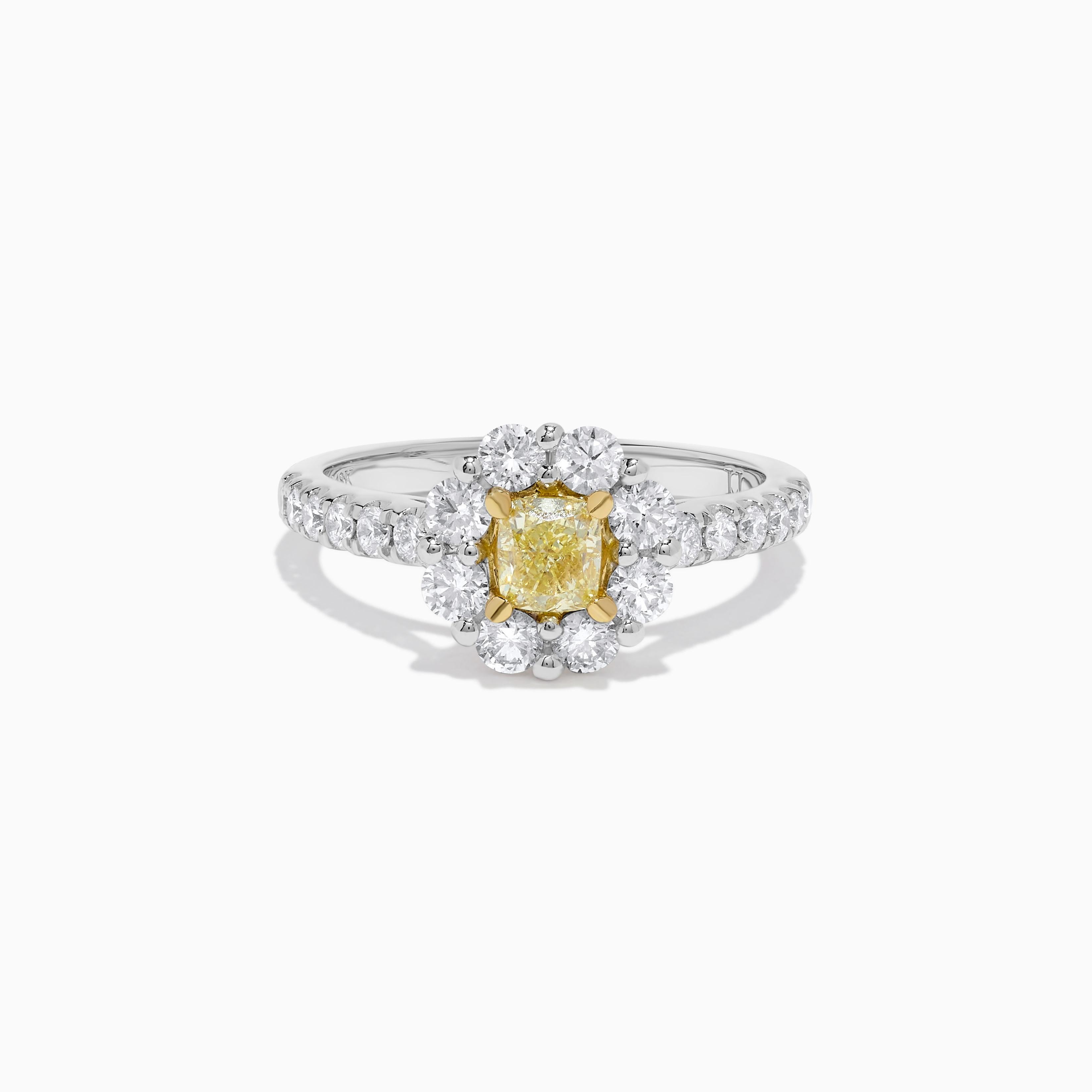 RareGemWorld's classic diamond ring. Mounted in a beautiful Platinum and 18K Gold setting with a natural cushion cut yellow diamond. The yellow diamond is surrounded by round natural white diamond melee. This ring is guaranteed to impress and