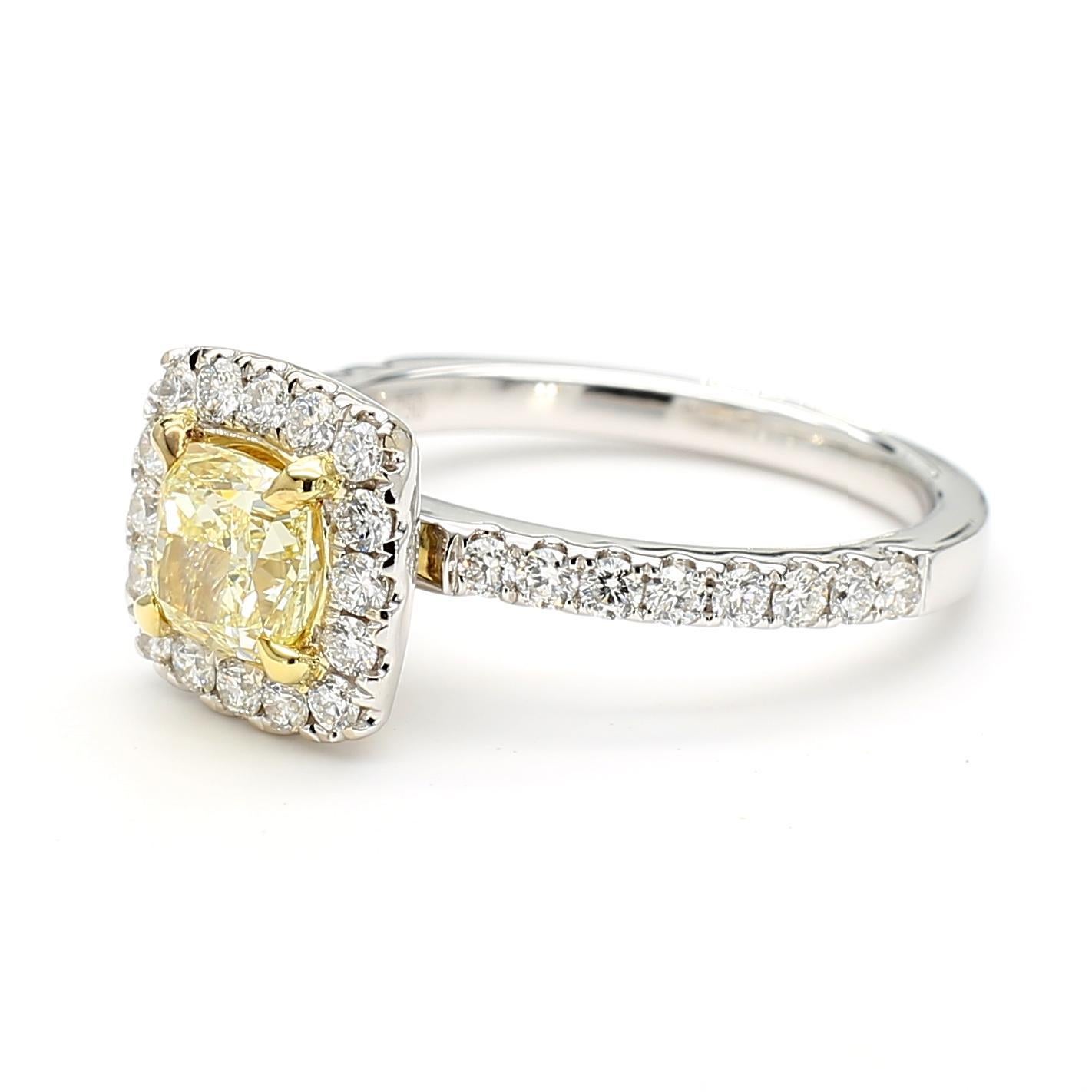 RareGemWorld's beautiful diamond ring. Mounted in a beautiful 18K Yellow and White Gold setting with a natural cushion cut yellow diamond. The yellow diamond is surrounded by round natural white diamond melee. This ring is guaranteed to impress and