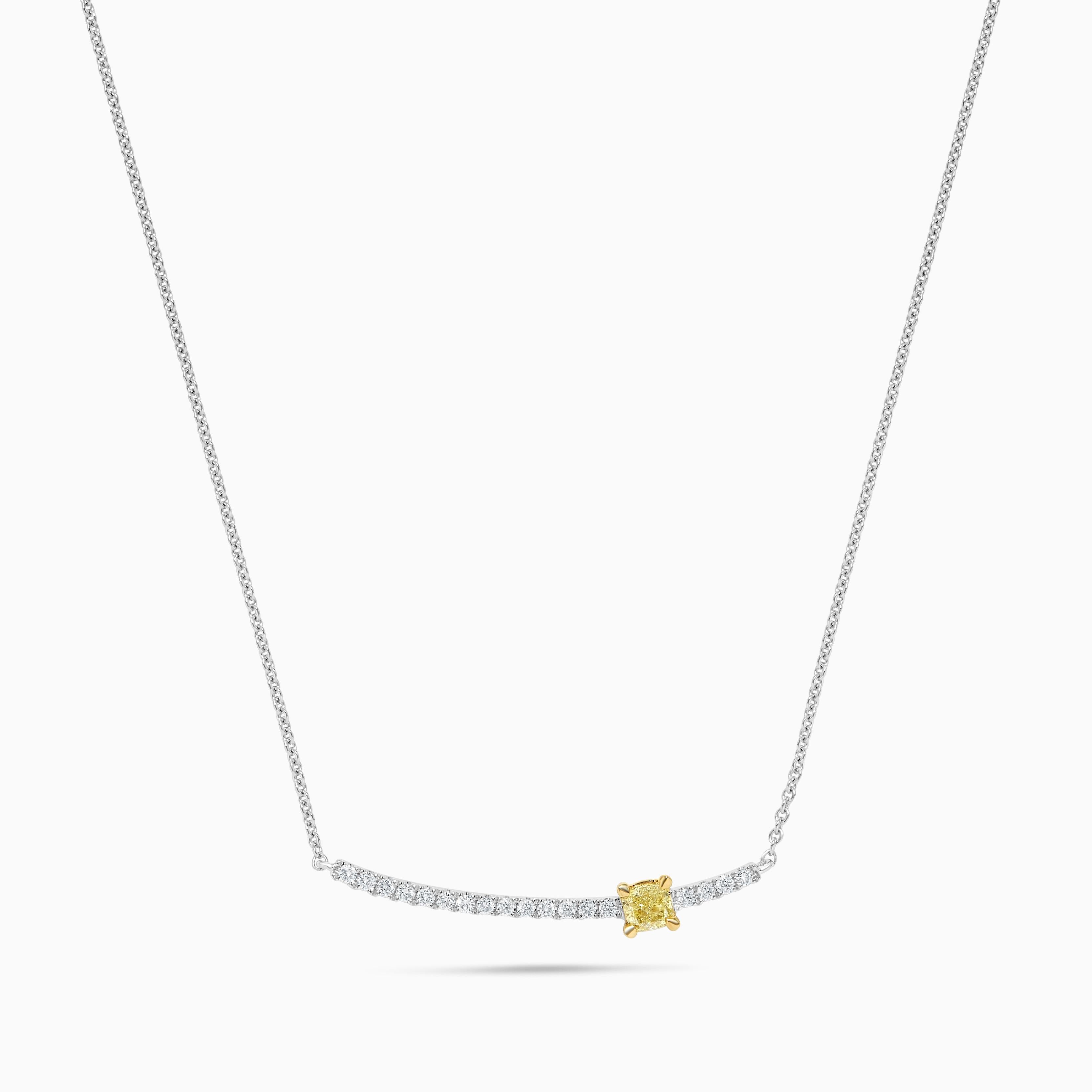 RareGemWorld's intriguing diamond necklace. Mounted in a beautiful 14K Yellow and White Gold setting with a natural cushion cut yellow diamond. The yellow diamond is surrounded by small round natural white diamond melee. This necklace is guaranteed