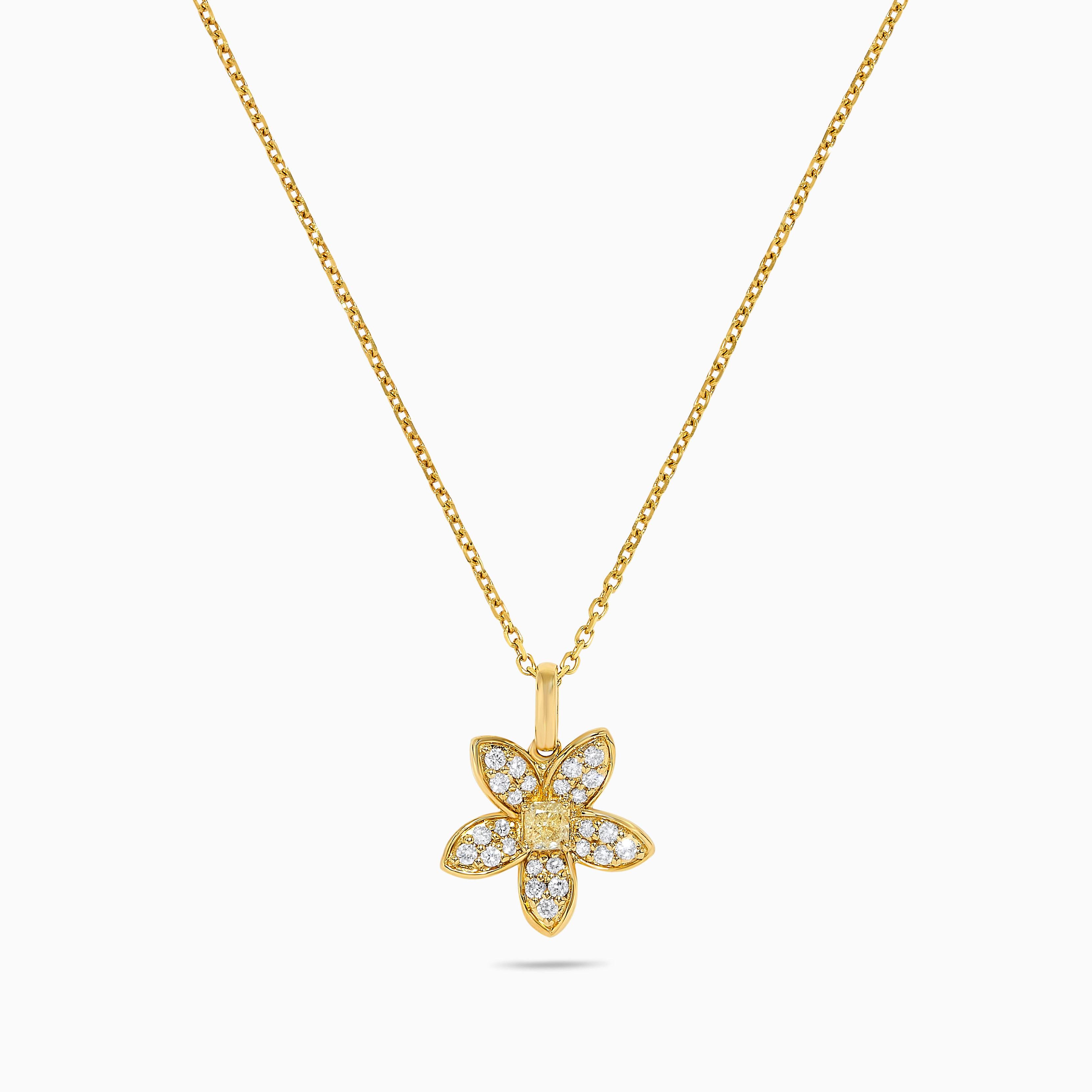 RareGemWorld's intriguing diamond pendant. Mounted in a beautiful 18K Yellow Gold setting with a natural cushion cut yellow diamond. The yellow diamond is surrounded by round natural white diamond melee. This pendant is guaranteed to impress and