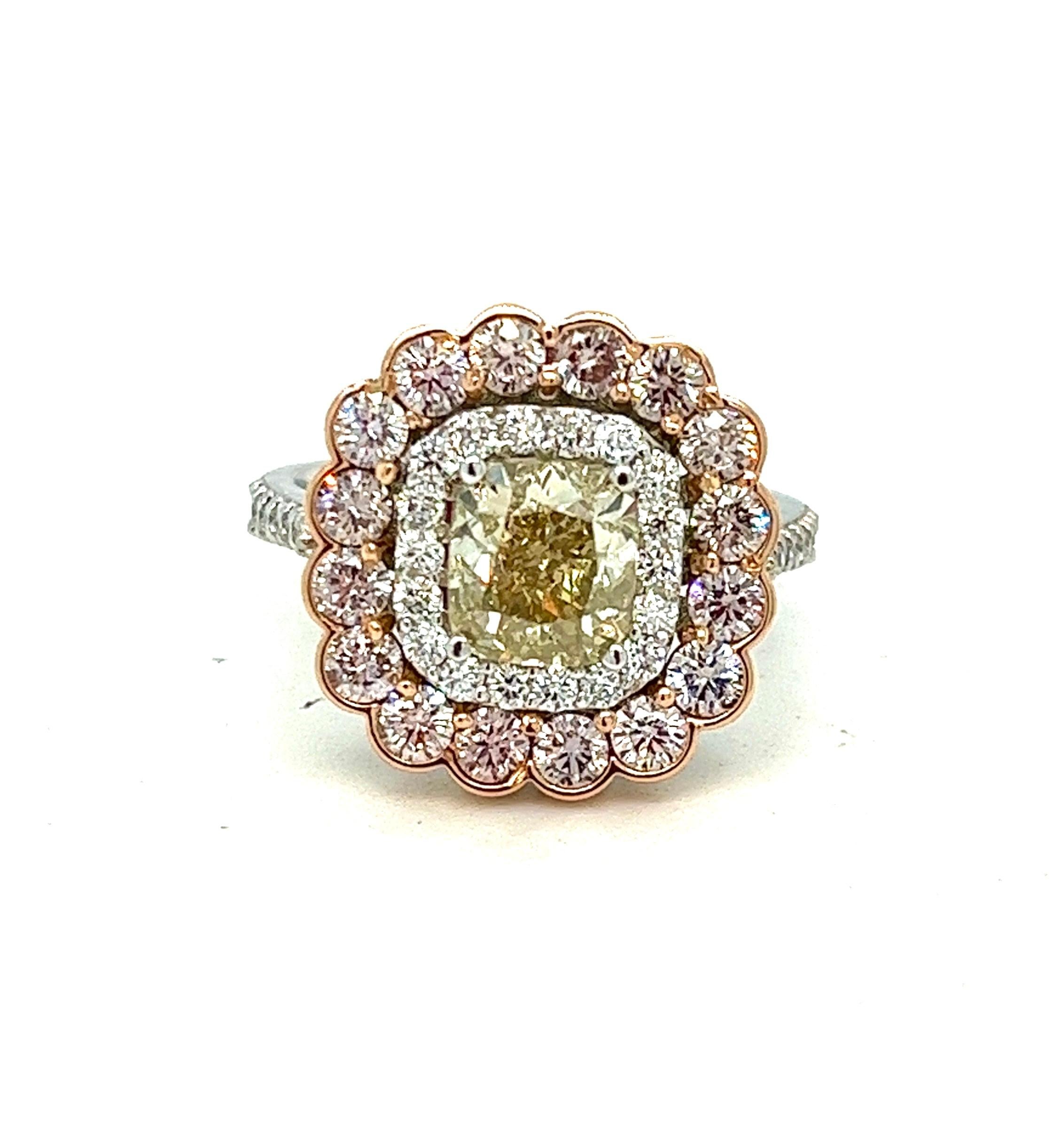Offered here is a Stunning Ring, adorned with natural multi-color diamonds.
Centered with one natural yellow cushion cut diamond, set in 4 prongs within a white diamond halo, which in turn is framed in a pink diamond frame, ring is further adorned