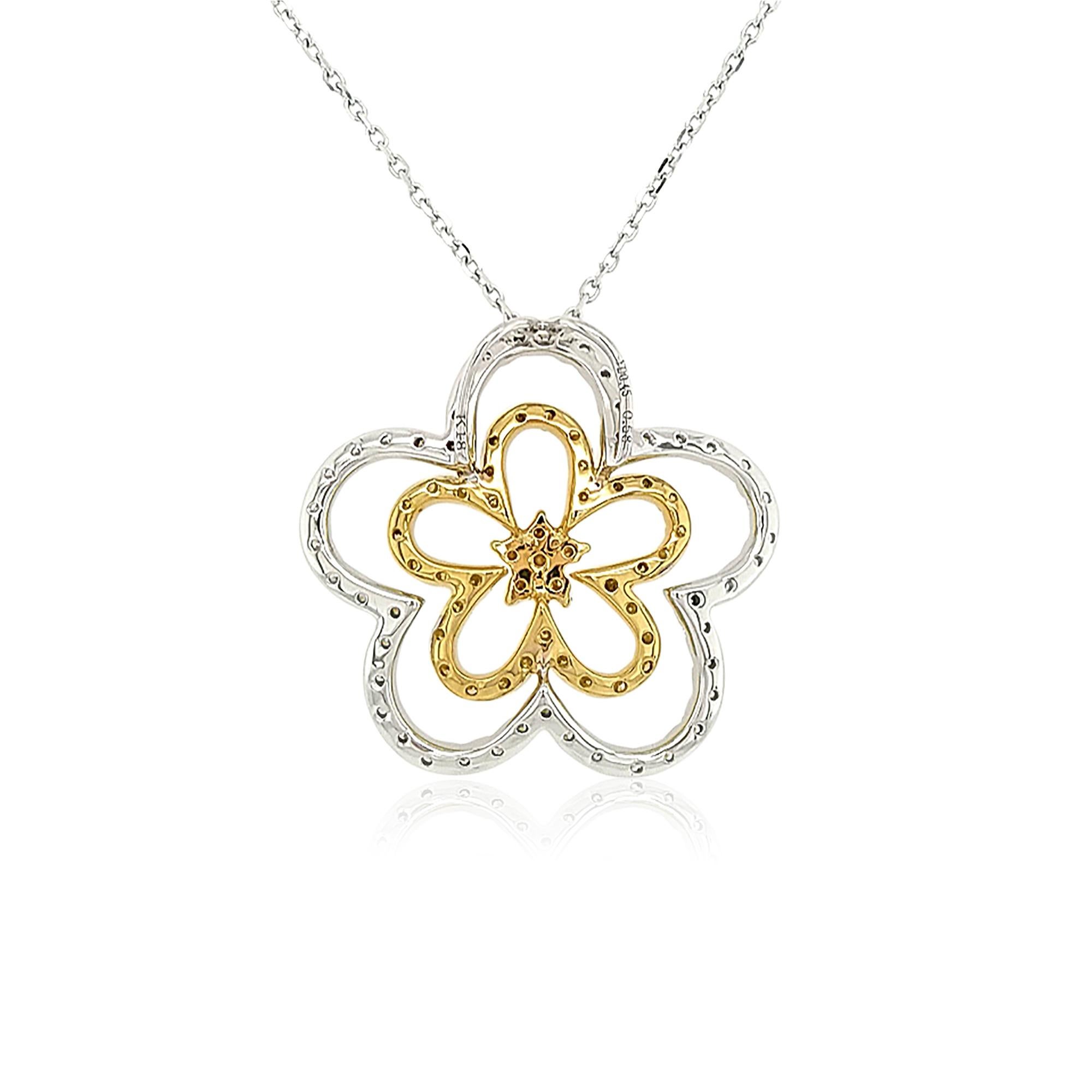 This unique 18K gold pendant features lustrous Yellow diamonds set amongst a floral motif of White diamonds. The diamonds intertwine to create two abstract flowers. A romantic, but striking piece, this beautiful pendant will add an exceptional
