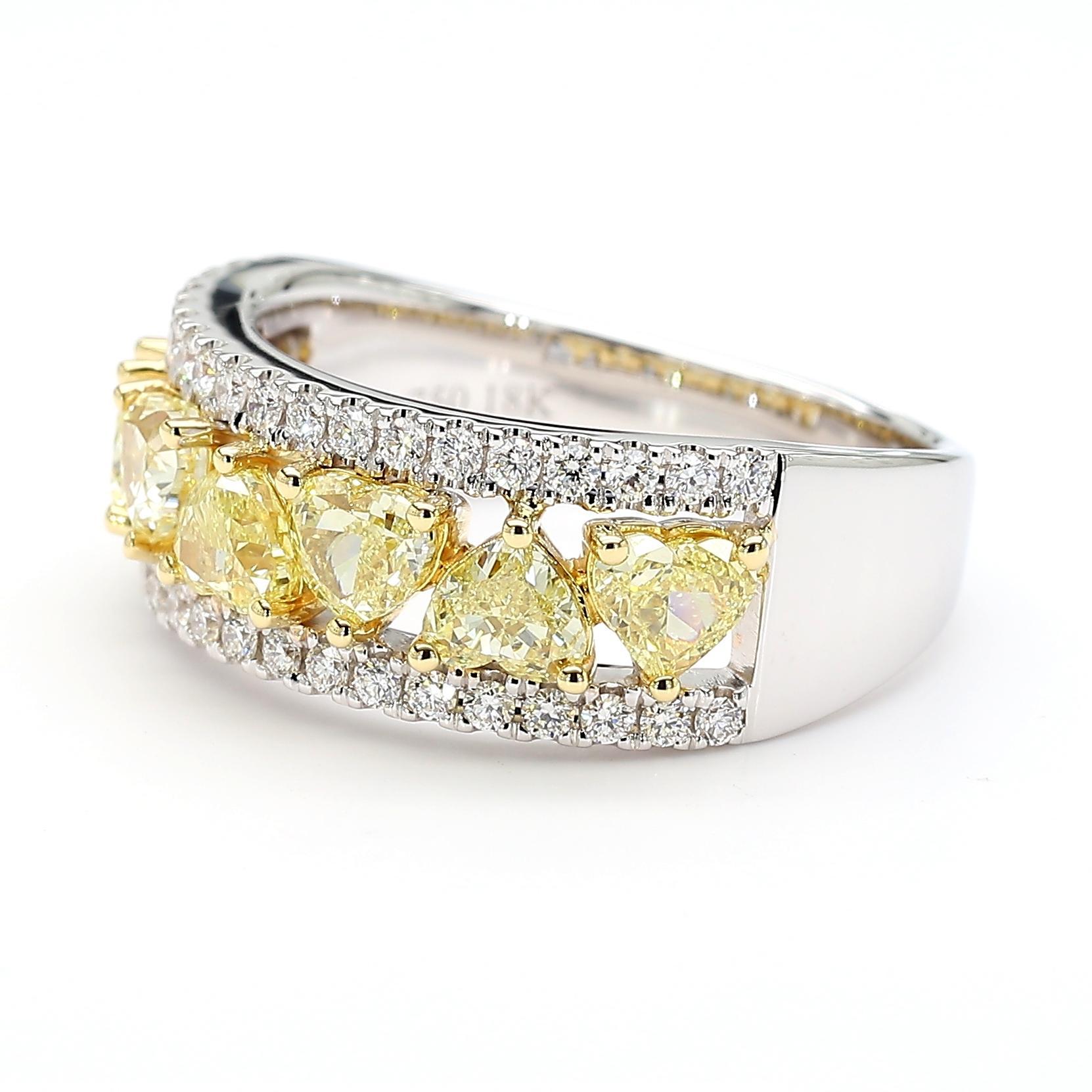 RareGemWorld's beautiful GIA certified diamond ring. Mounted in a beautiful 18K Yellow and White setting with two natural heart cut yellow diamonds. The yellow diamonds are surrounded by round natural white diamond melee. This ring is guaranteed to