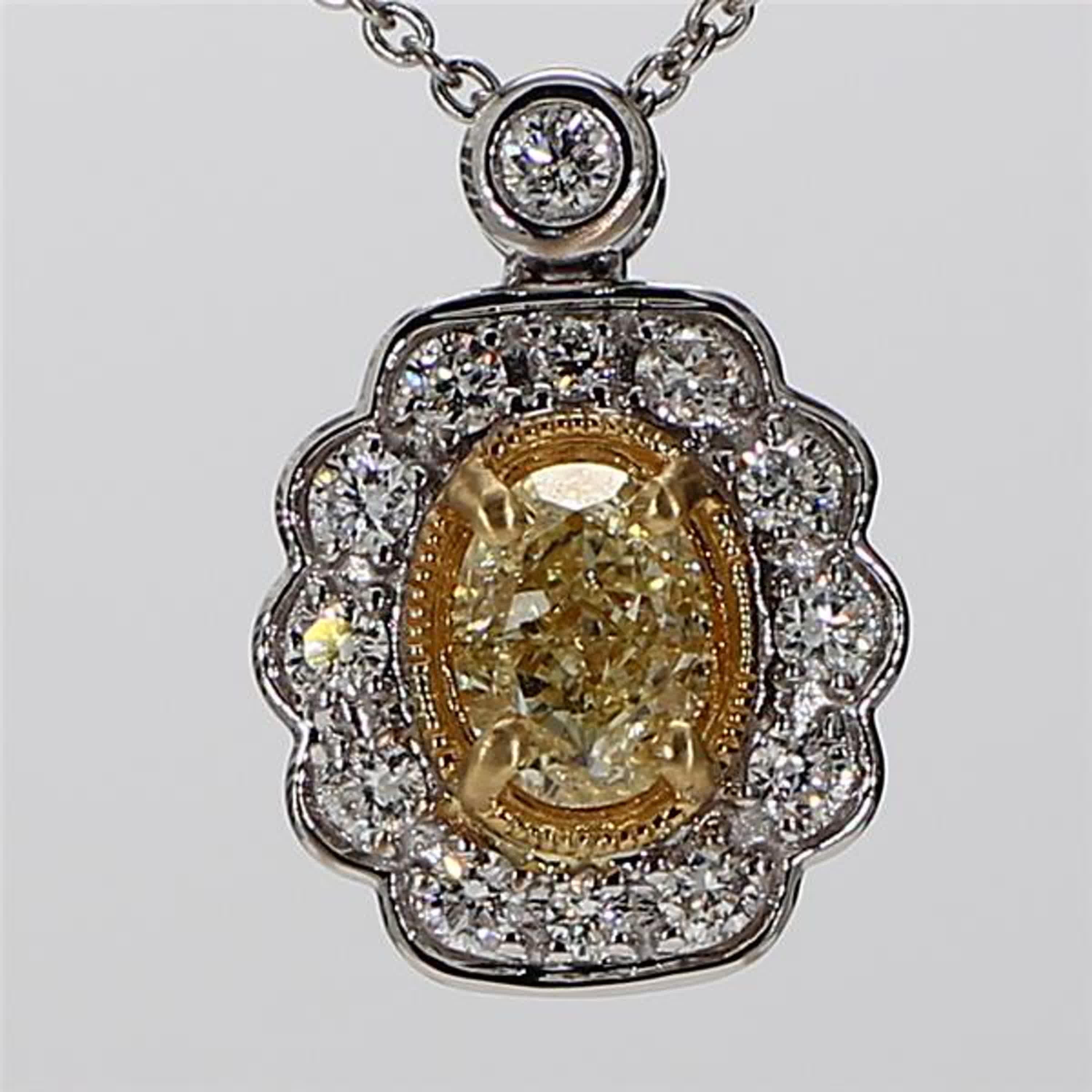 RareGemWorld's classic diamond pendant. Mounted in a beautiful 18K Yellow and White Gold setting with a natural cushion cut yellow diamond. The yellow diamond is surrounded by natural round white diamond melee. This pendant is guaranteed to impress