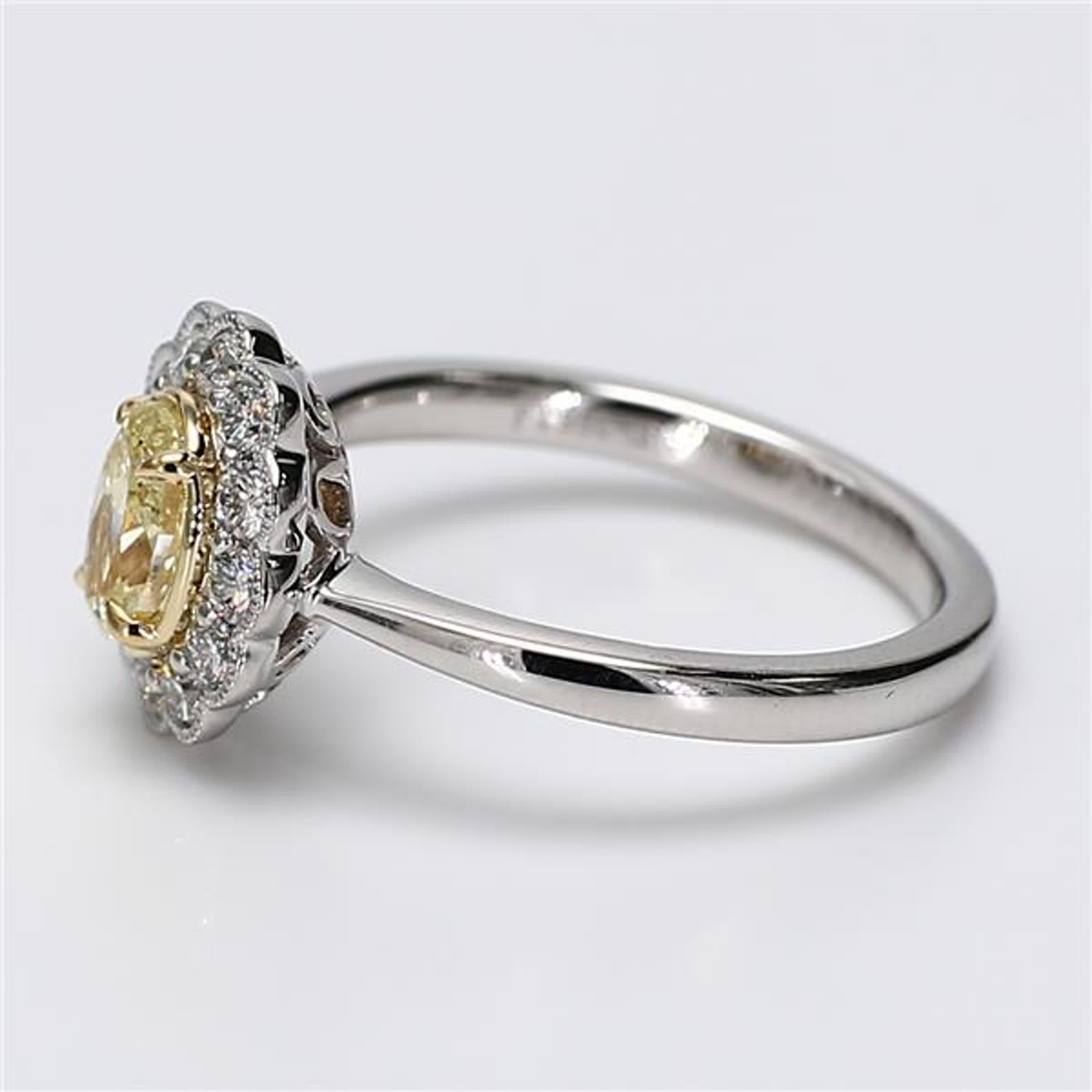 RareGemWorld's classic diamond ring. Mounted in a beautiful Platinum/18K Yellow and White Gold setting with a natural oval cut yellow diamond. The yellow diamond is surrounded by round natural white diamond melee. This ring is guaranteed to impress