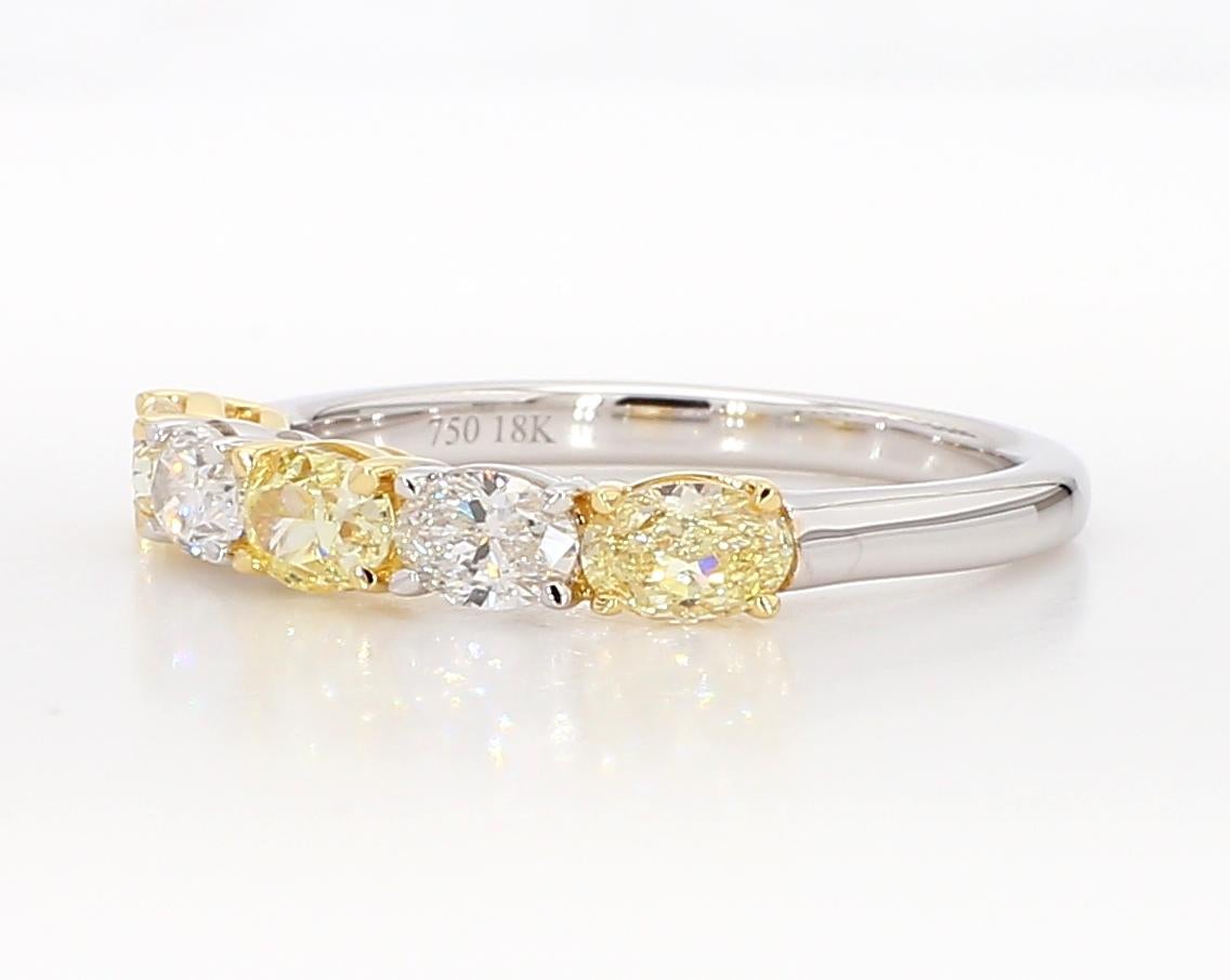 RareGemWorld's classic diamond ring. Mounted in a beautiful 18K Yellow and White Gold setting with natural oval cut yellow diamonds complimented with natural oval cut white diamonds. This ring is guaranteed to impress and enhance your personal