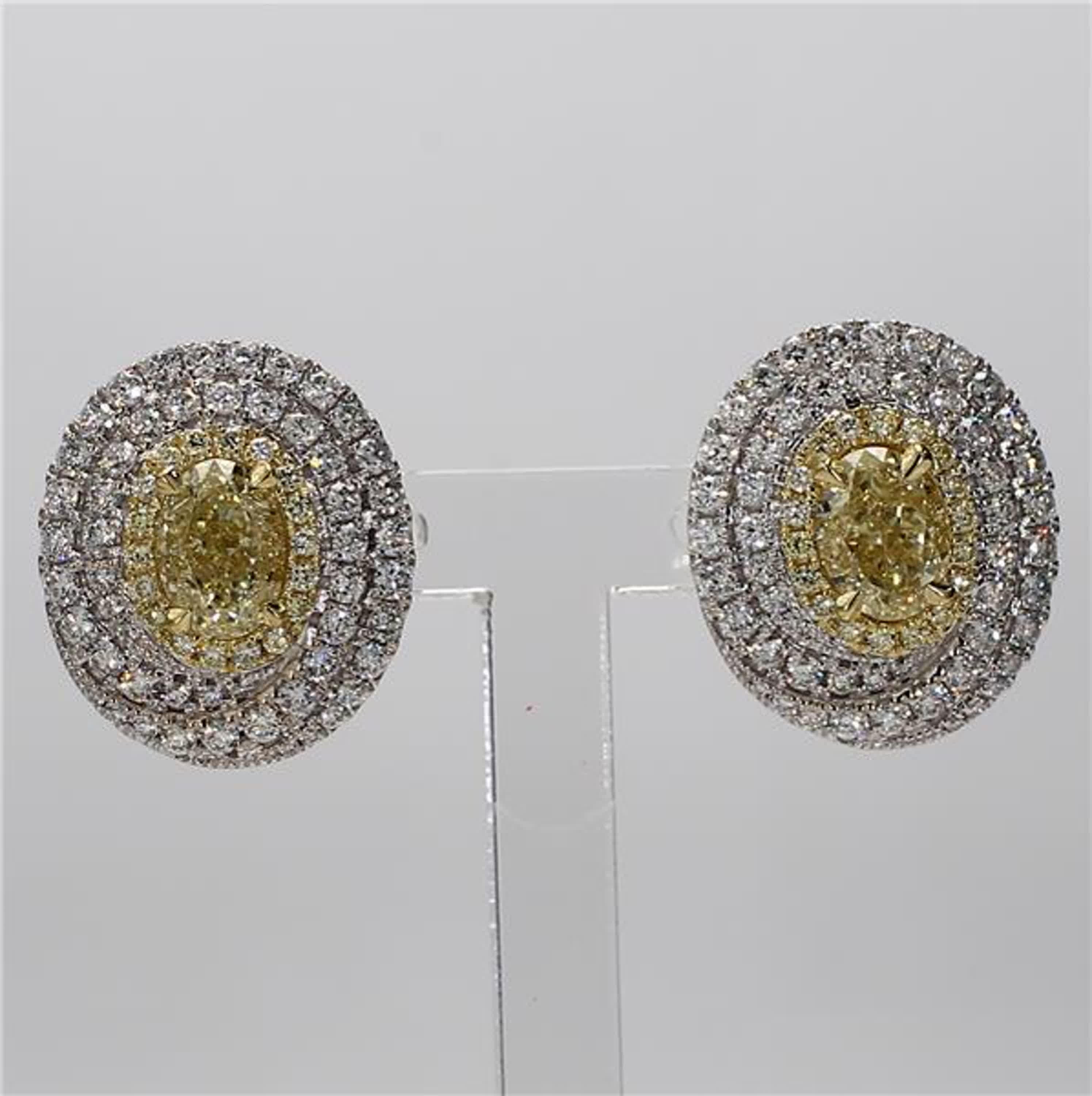 RareGemWorld's classic diamond earrings. Mounted in a beautiful 18K Yellow and White Gold setting with natural oval cut yellow diamonds. The yellow diamonds are surrounded by round natural yellow diamond melee and round natural white diamond melee.