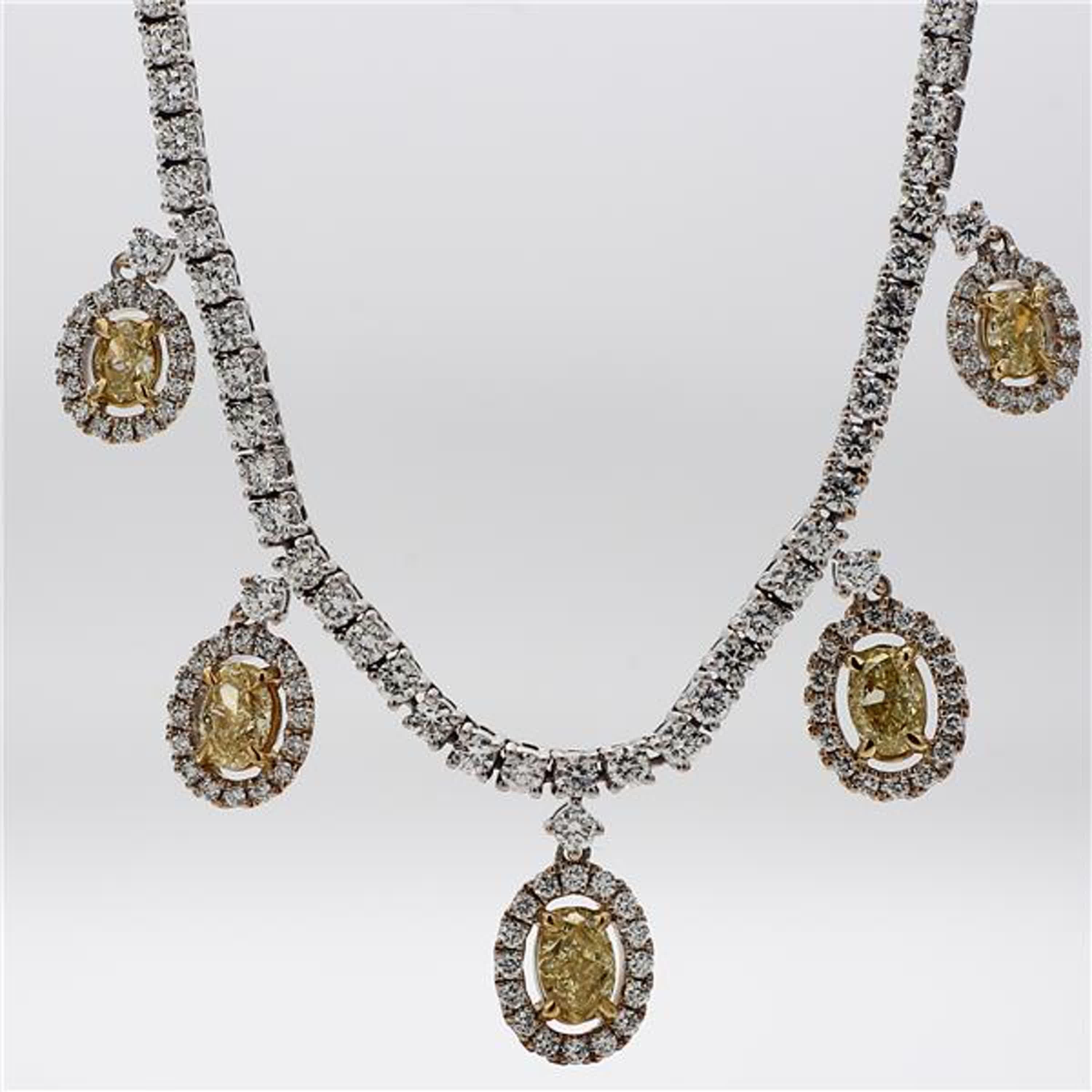 RareGemWorld's classic diamond necklace. Mounted in a beautiful 18K Yellow and White Gold setting with natural oval cut yellow diamonds. The yellow diamonds are surrounded by small round natural white diamond melee as well as diamonds throughout the