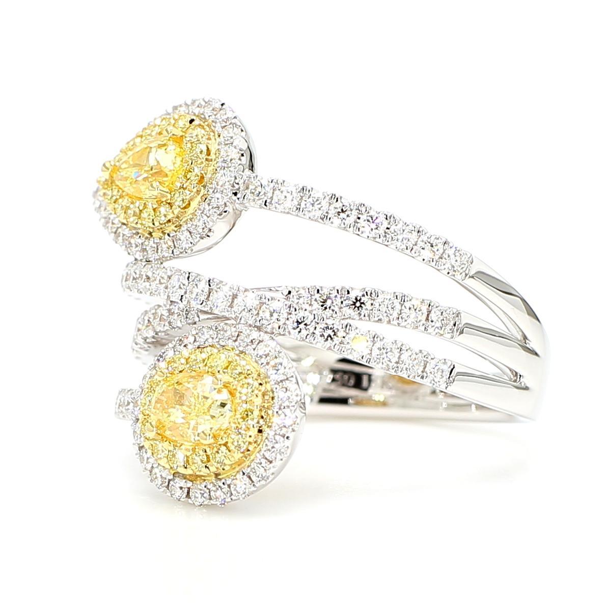 RareGemWorld's beautiful GIA certified diamond ring. Mounted in a beautiful 18K Yellow and White setting with a natural pear cut yellow diamond and a natural oval cut yellow diamond. The yellow diamonds are surrounded by round natural white diamond