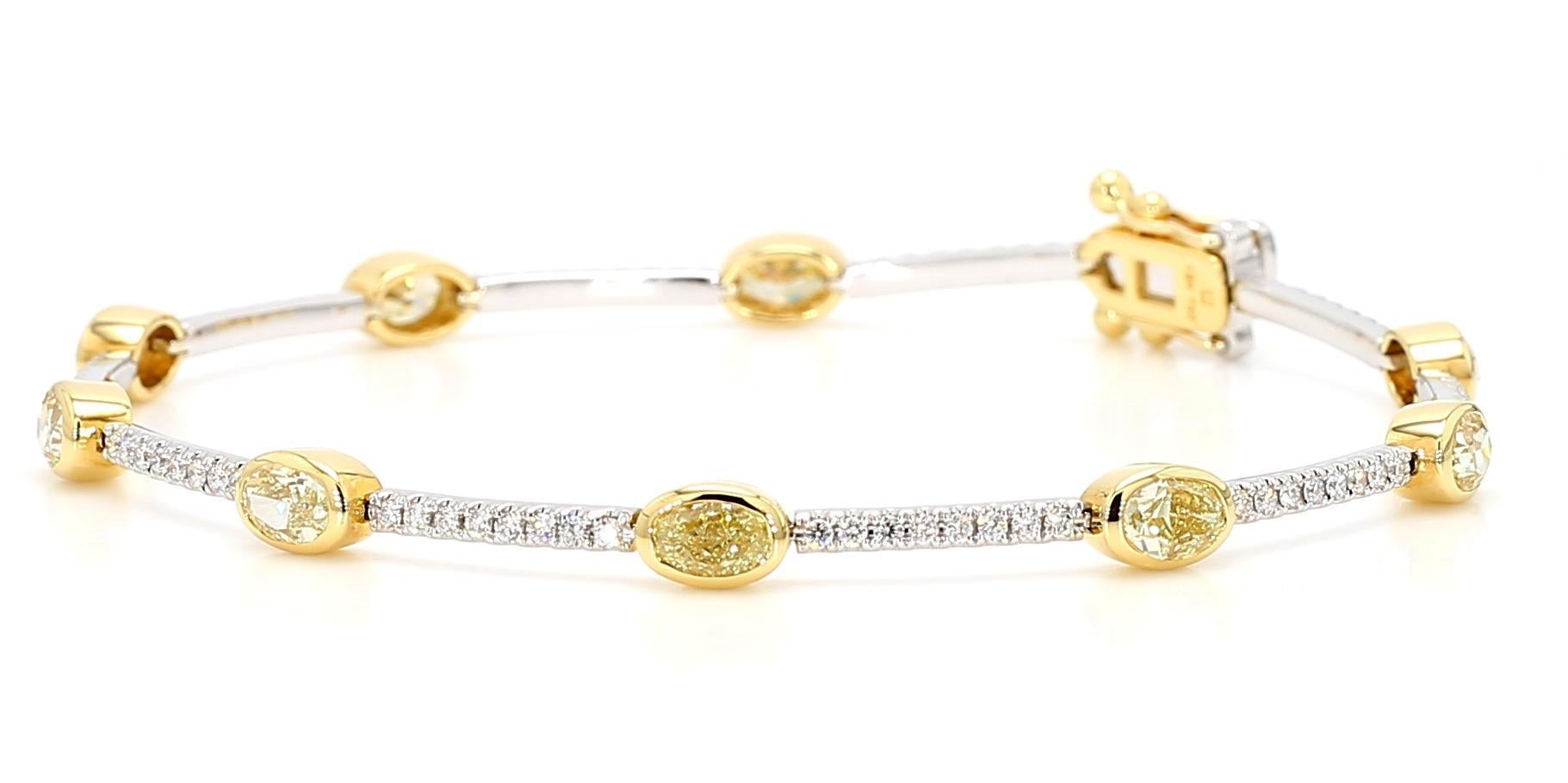 RareGemWorld's beautiful diamond bracelet. Mounted in a beautiful 18K Yellow and White Gold setting with natural oval cut yellow diamonds complimented by natural round cut white diamond melee. This bracelet is guaranteed to impress and will enhance