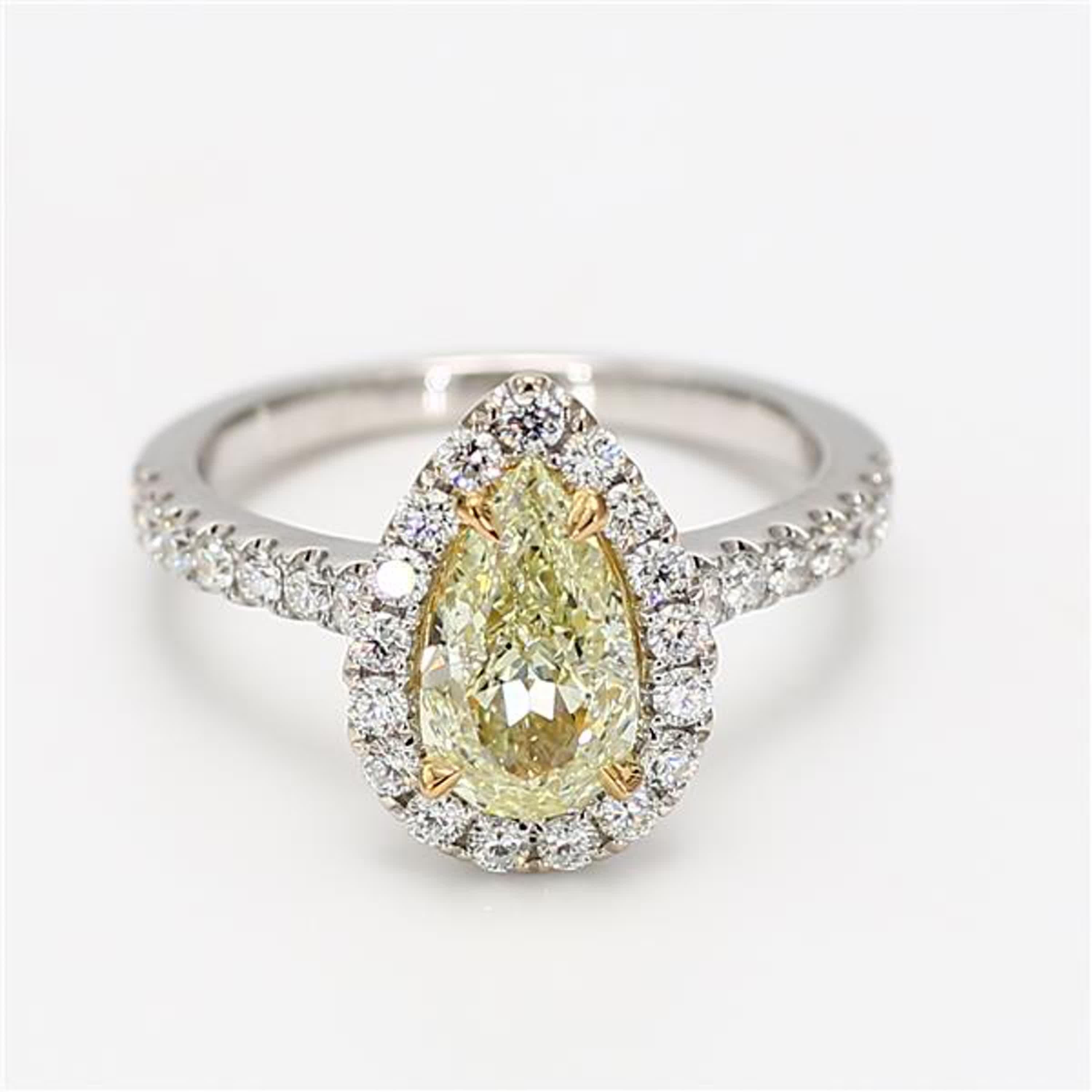 RareGemWorld's classic diamond ring. Mounted in a beautiful 18K Yellow and White Gold setting with a natural pear cut yellow diamond. The yellow diamond is surrounded by round natural white diamond melee. This ring is guaranteed to impress and