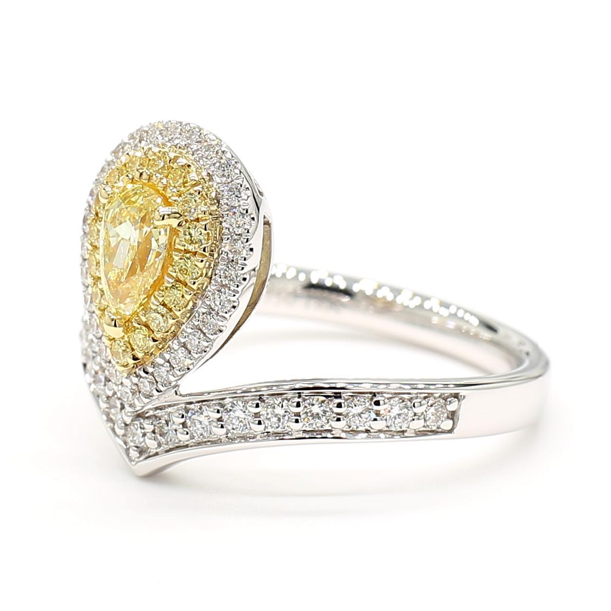 RareGemWorld's beautiful diamond ring. Mounted in a beautiful 18K Yellow and White setting with a natural pear cut yellow diamond surrounded by round natural white diamond melee and round natural yellow diamond melee. This ring is guaranteed to