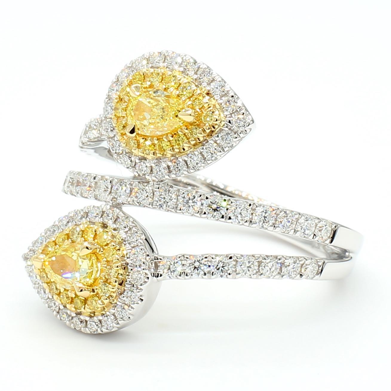 RareGemWorld's classic GIA certified diamond ring. Mounted in a beautiful 18K Yellow and White setting with two natural pear cut yellow diamonds. The yellow diamonds are surrounded by round natural white diamond melee and round natural yellow