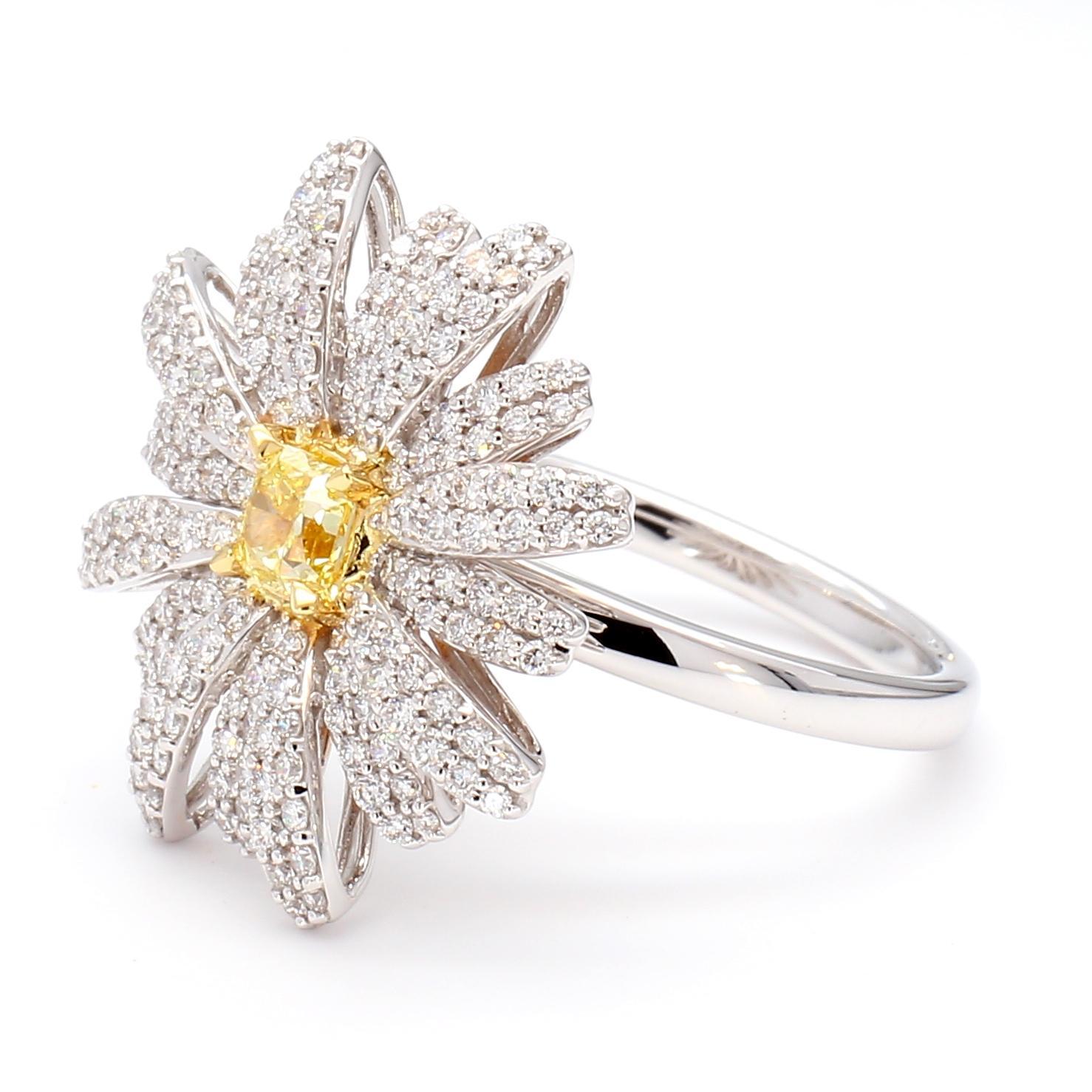 RareGemWorld's classic diamond ring. Mounted in a beautiful 18K Yellow and White Gold setting with a natural radiant cut yellow diamond. The yellow diamond is surrounded by round natural white diamond melee. This ring is guaranteed to impress and